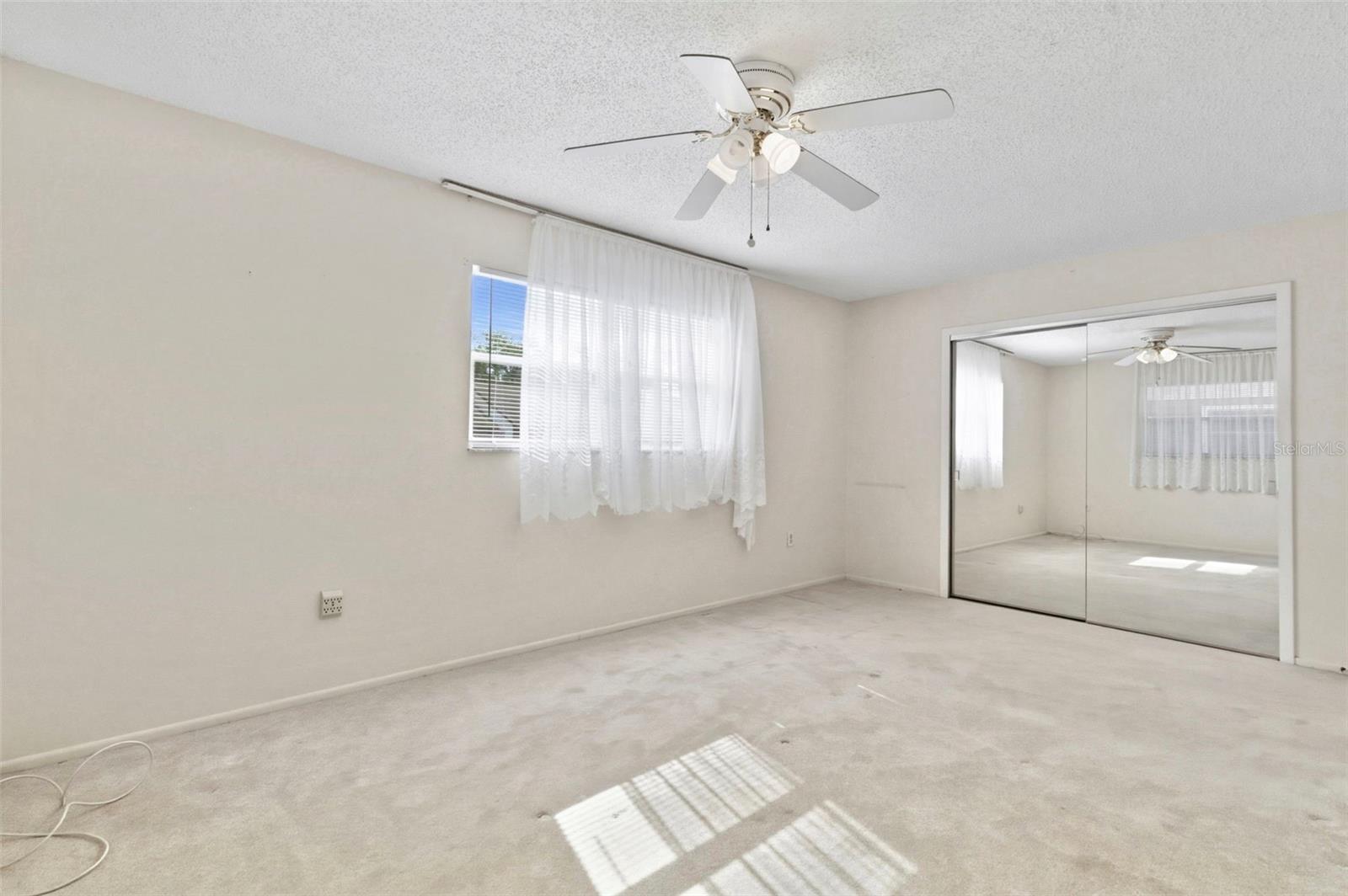 Mirrored closet doors are found on the spacious closet.