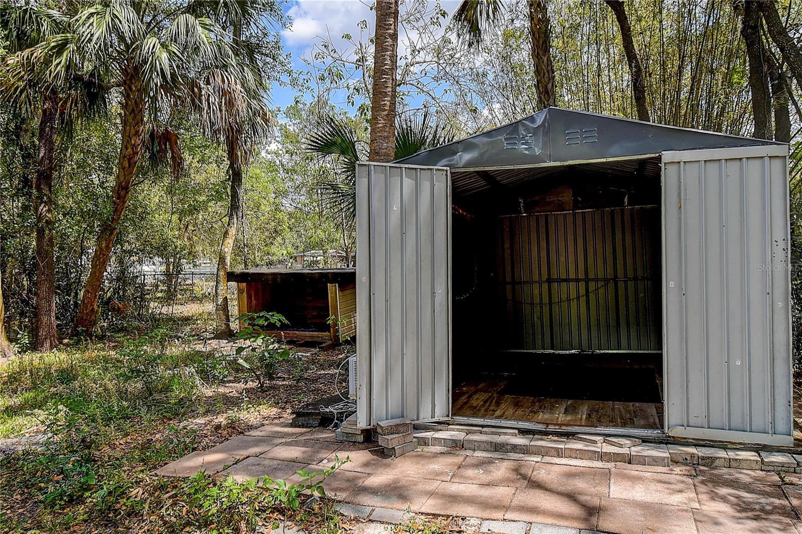 Dog house on left, and storage shed on right
