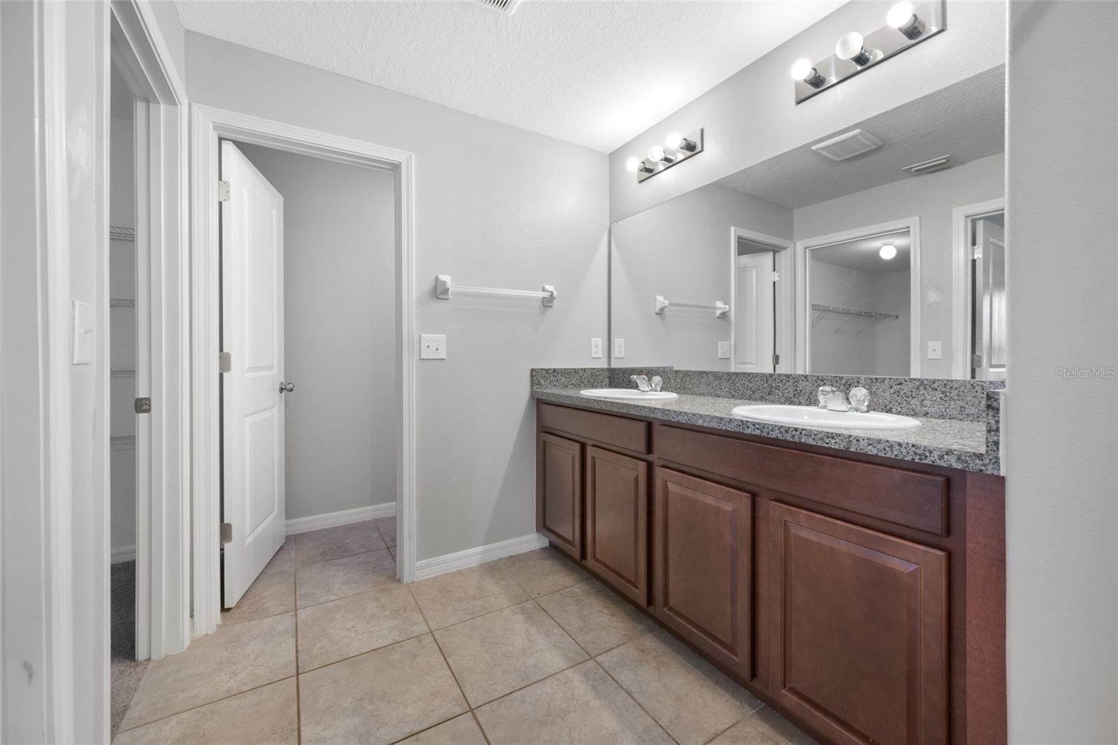 Primary Bathroom with Dual Sinks and a Water Closet