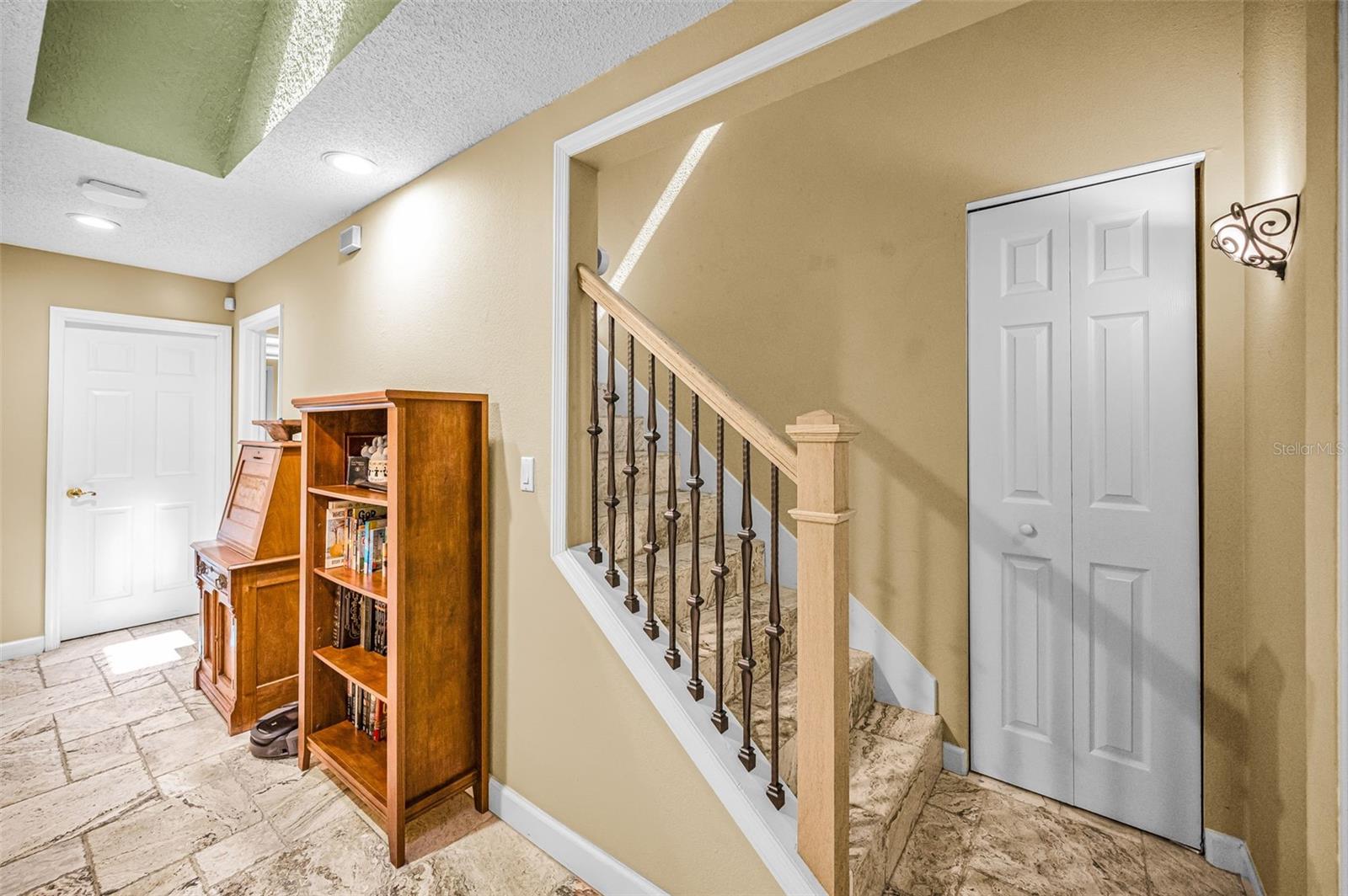 Stairs with Travertine flooring leading to upstairs bedrooms