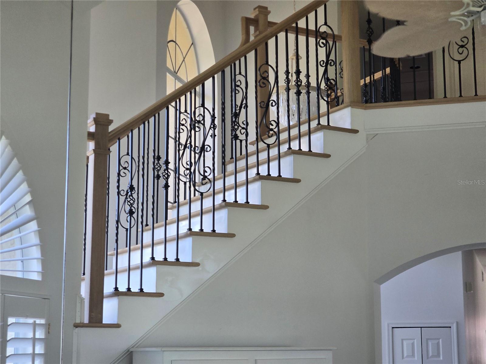 Mirror in living room reflects bespoke balustrades