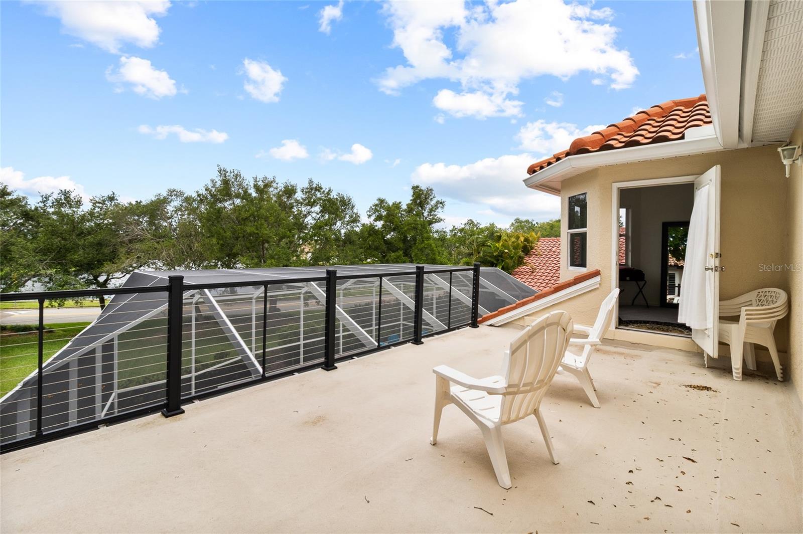 Private access from primary bedroom to private balcony.  Bring a cocktail and take in the sunset over the lake!