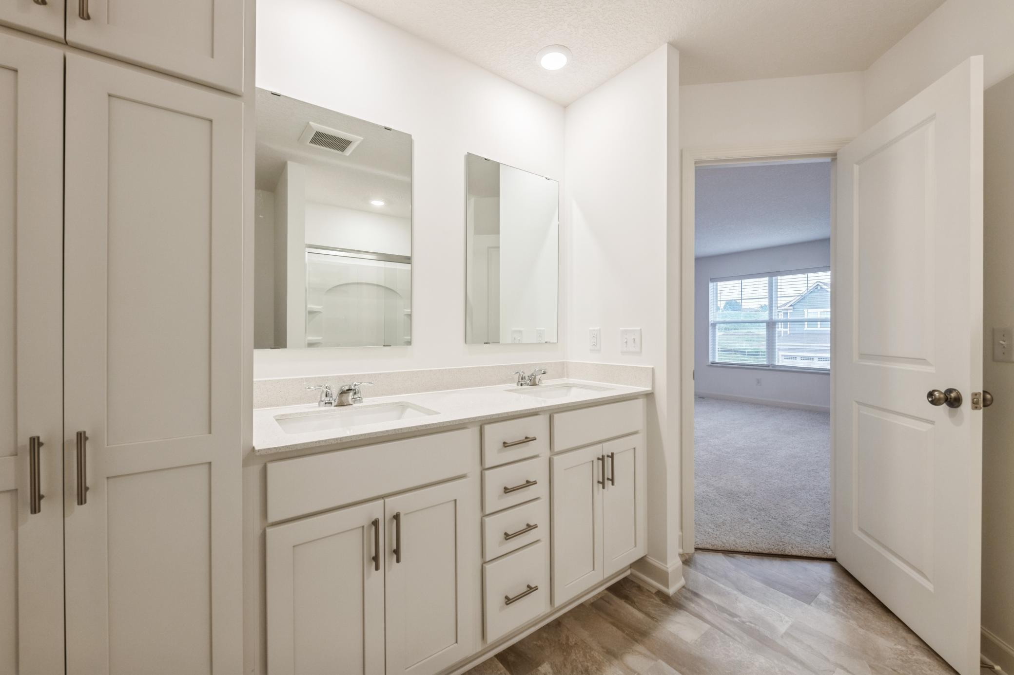(Photo of a similar home, actual homes finishes will vary) An extension of the primary suite, this private and spacious bath contains a double vanity and a separate shower.
