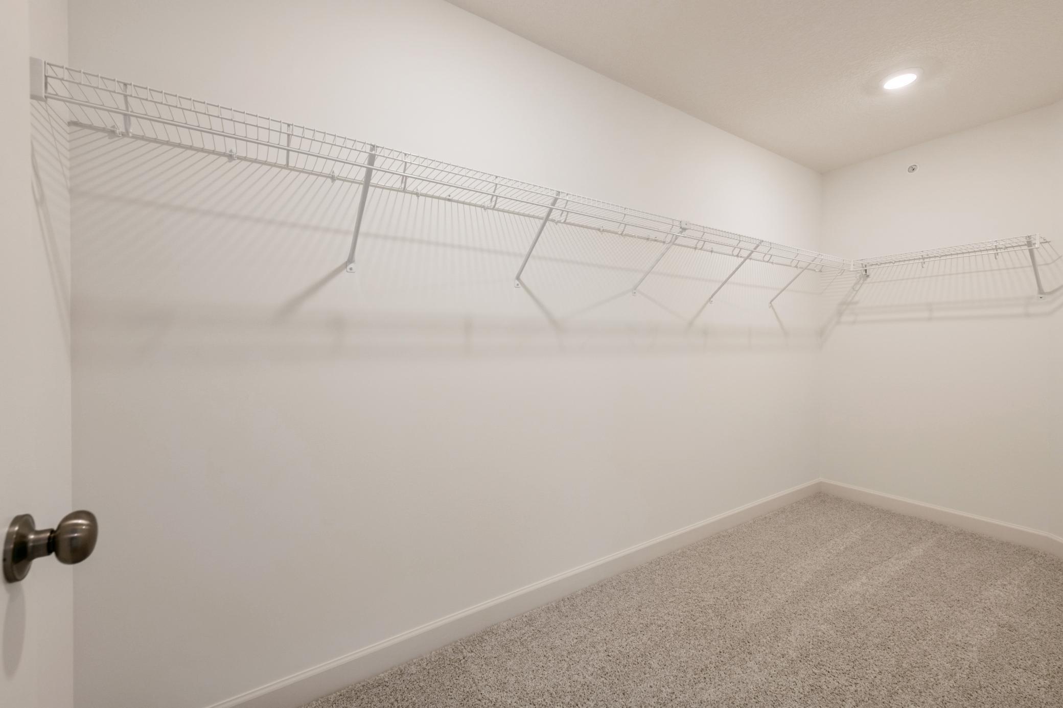 (Photo of a similar home, actual homes finishes will vary) The primary suite features an incredible walk-in closet.