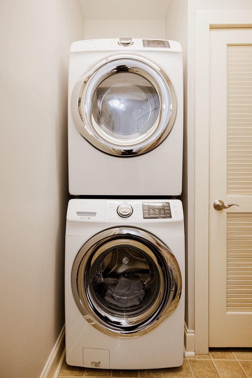 Laundry room is to the right of front entry way, large coat closet in foyer entry and hidden utilities closet in laundry room