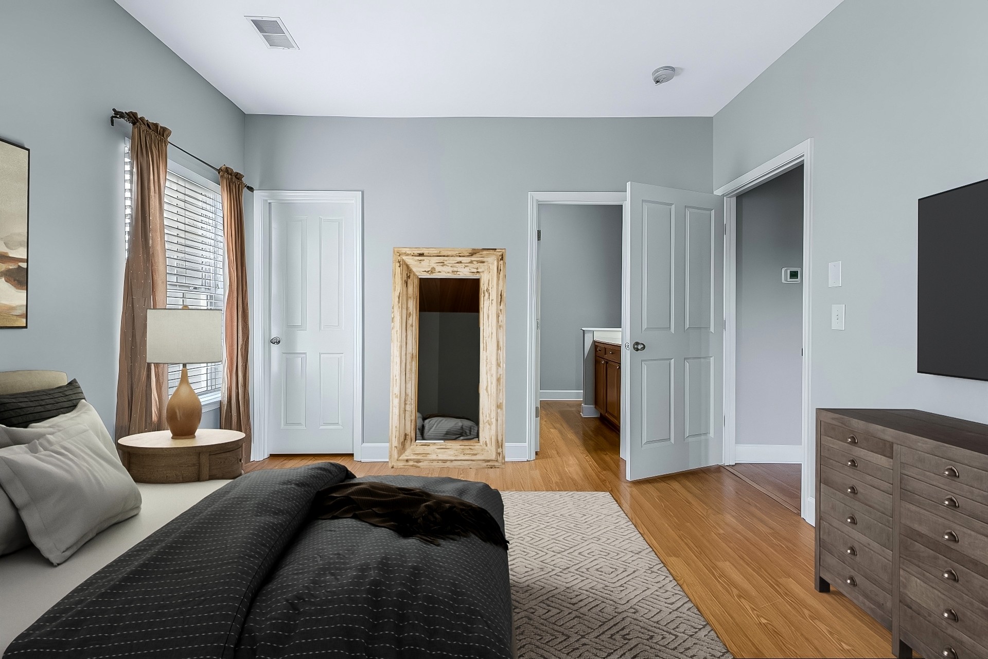 This is a virtually staged photo of the primary bedroom.