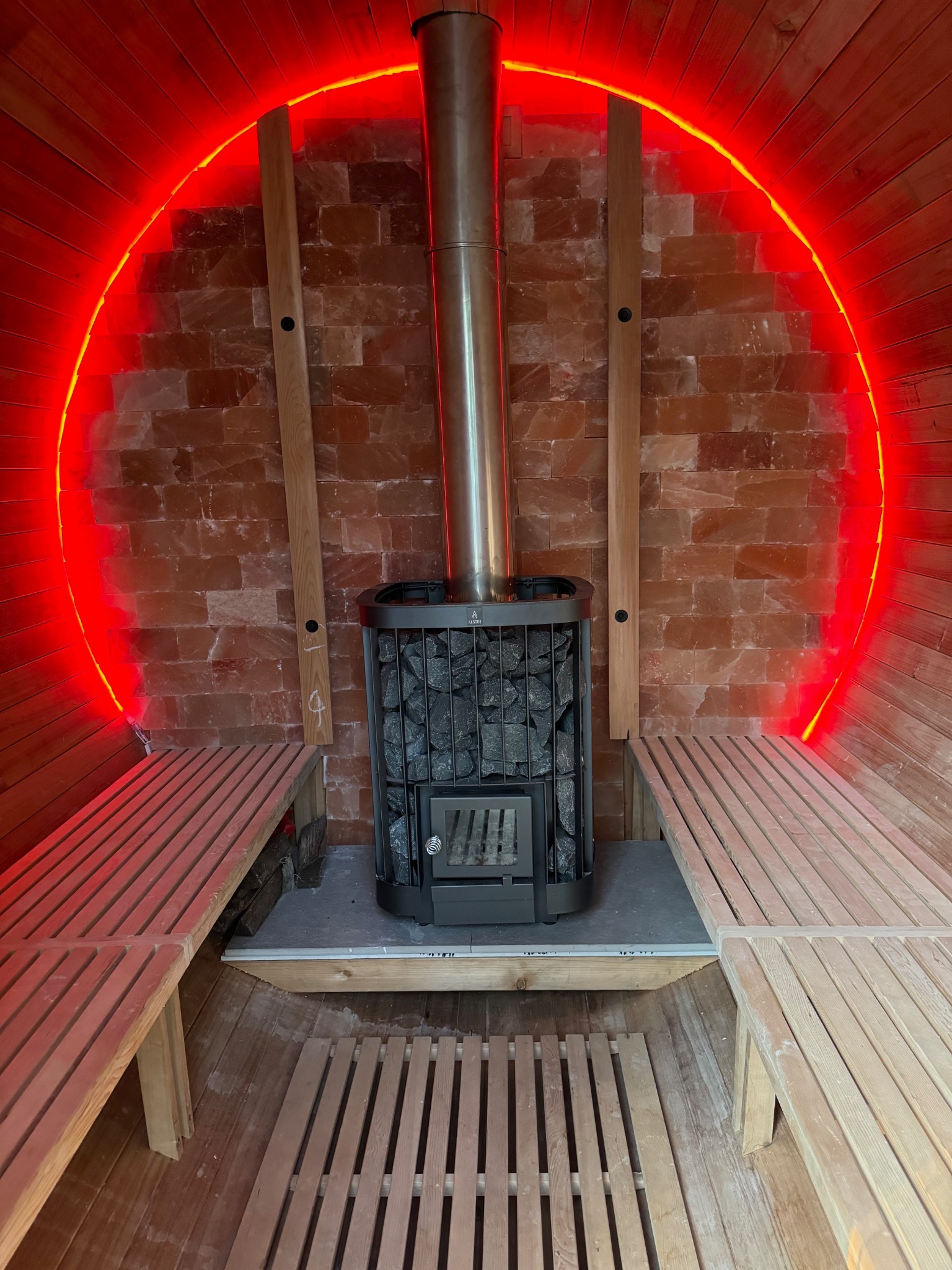 The inside of the sauna has a Himalayan salt block wall and traditional rock and wood burning sauna this allows bather to have steam or sauna with the benefit of the healing affects of the salt ions released into the room