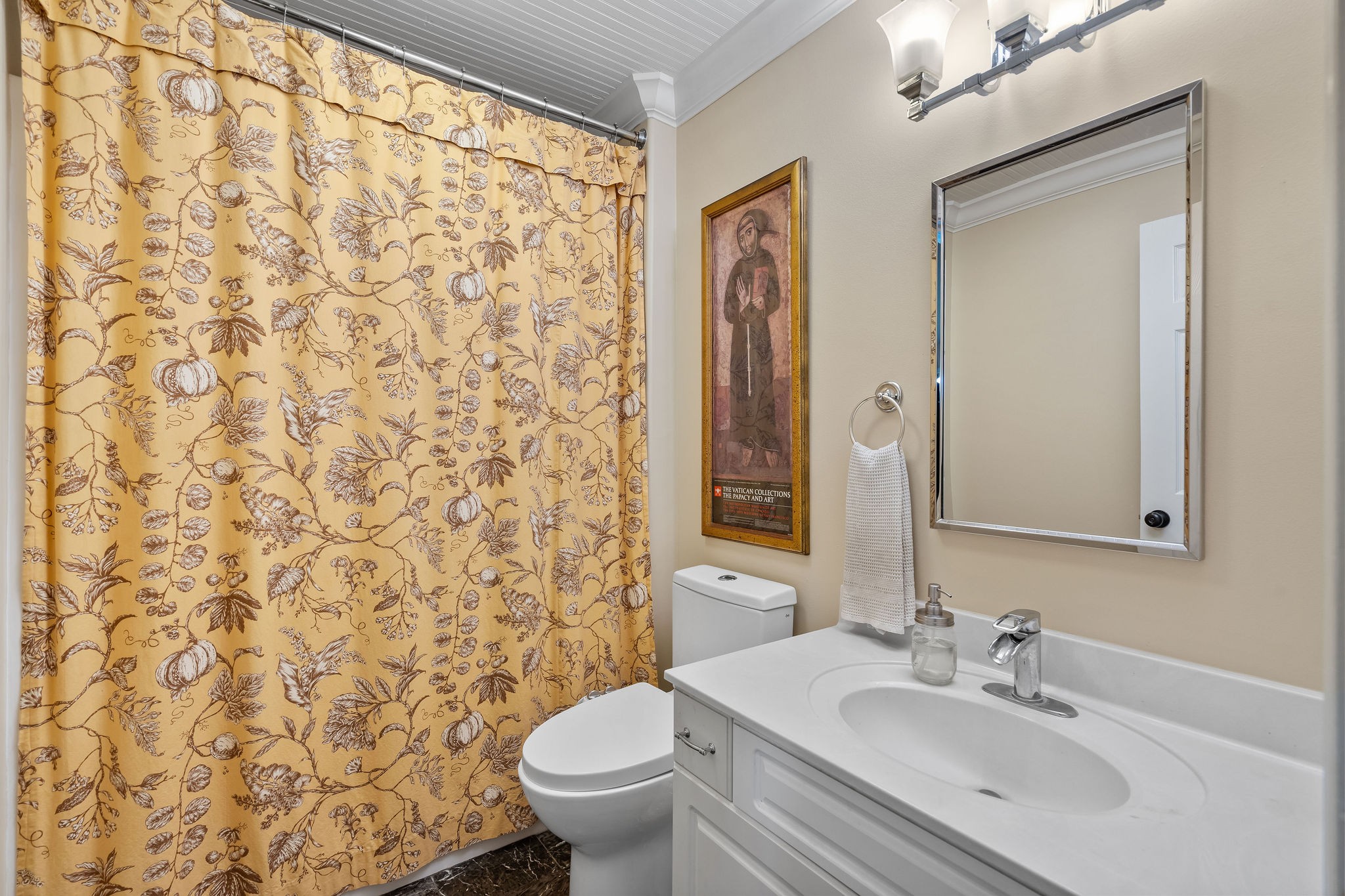 This bath services two of the downstairs bedrooms. It has some nice vintage touches including wide crown molding and beaded wood ceiling sourced in the area. This bath also features an very large walk-in shower.