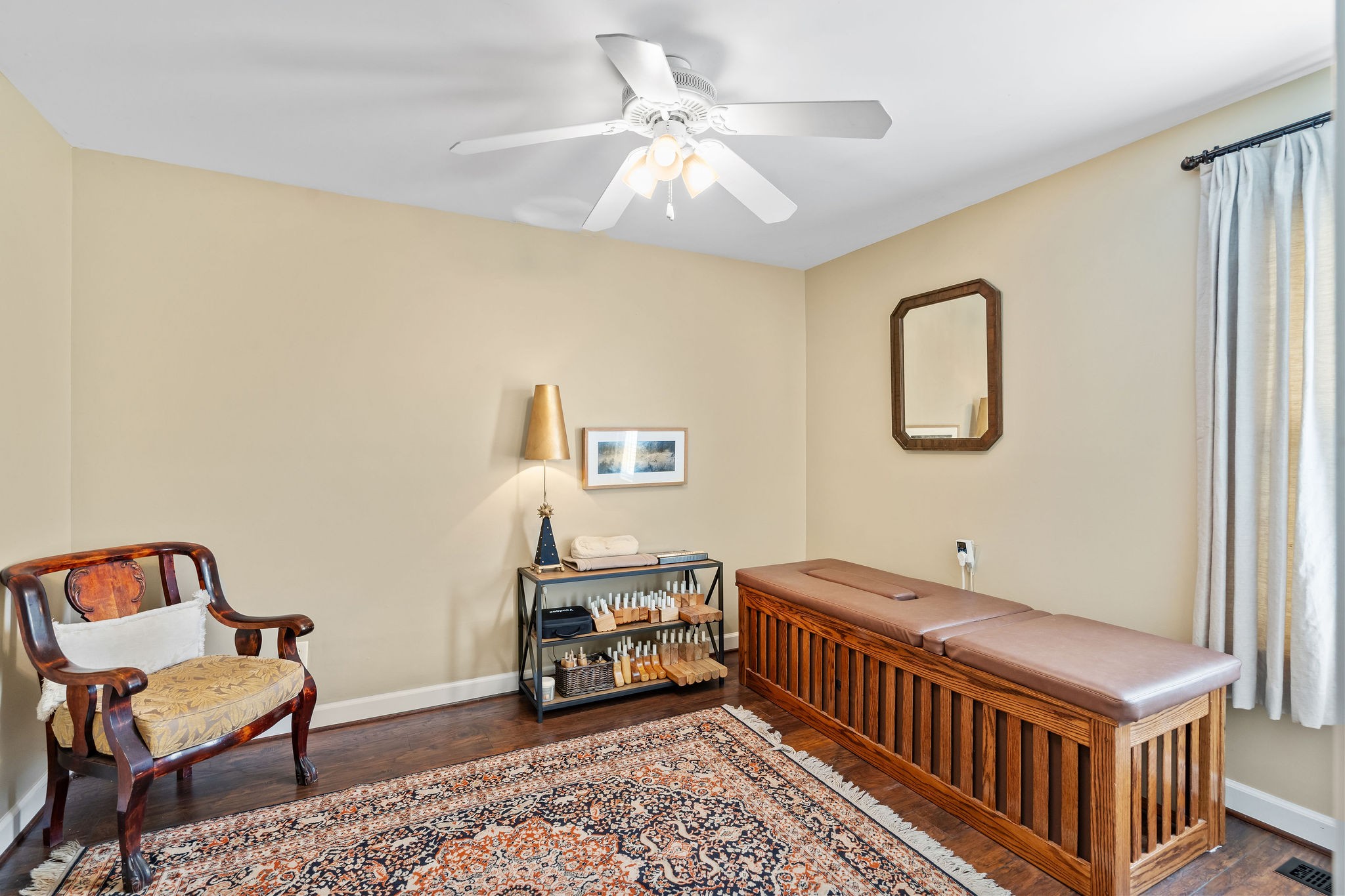 Bedroom 3 of 3 is currently being used as a spa room. It features the same wood flooring and new decorator paint found throughout the house.