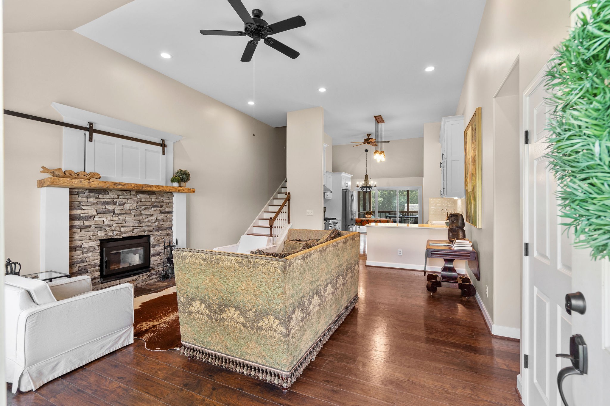 Beautiful wood flooring, high ceilings, a high-efficiency wood burning fireplace with stacked stone surround greet you as you walk through the front door!