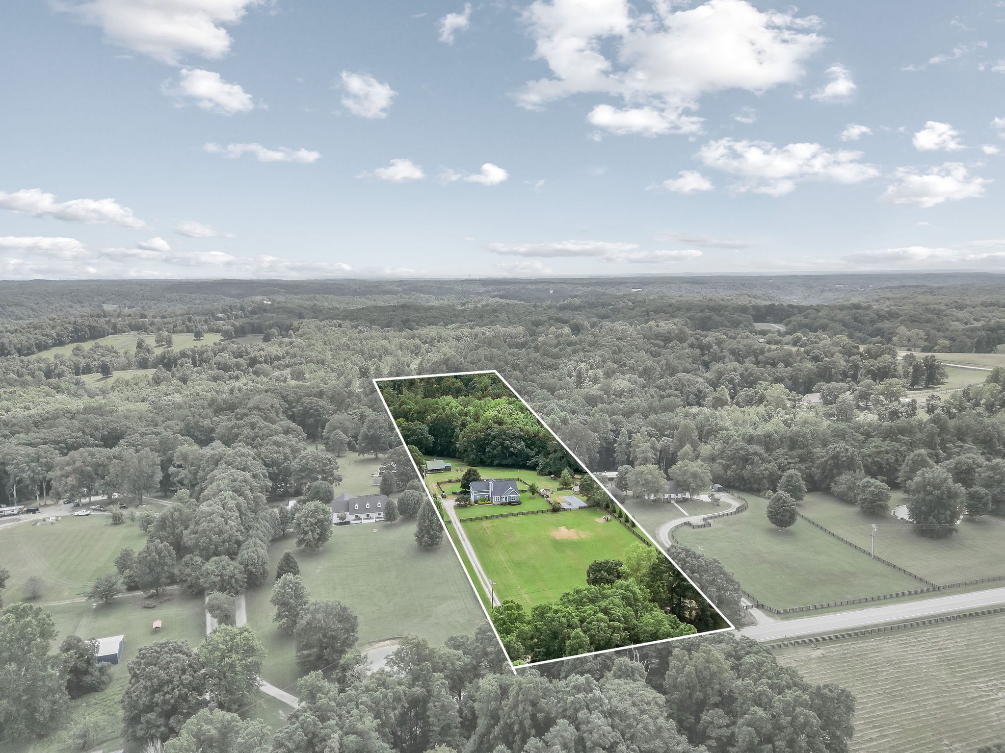 The 5.13 acre property extends into the woods behind the barn and features a year-round spring-fed creek.