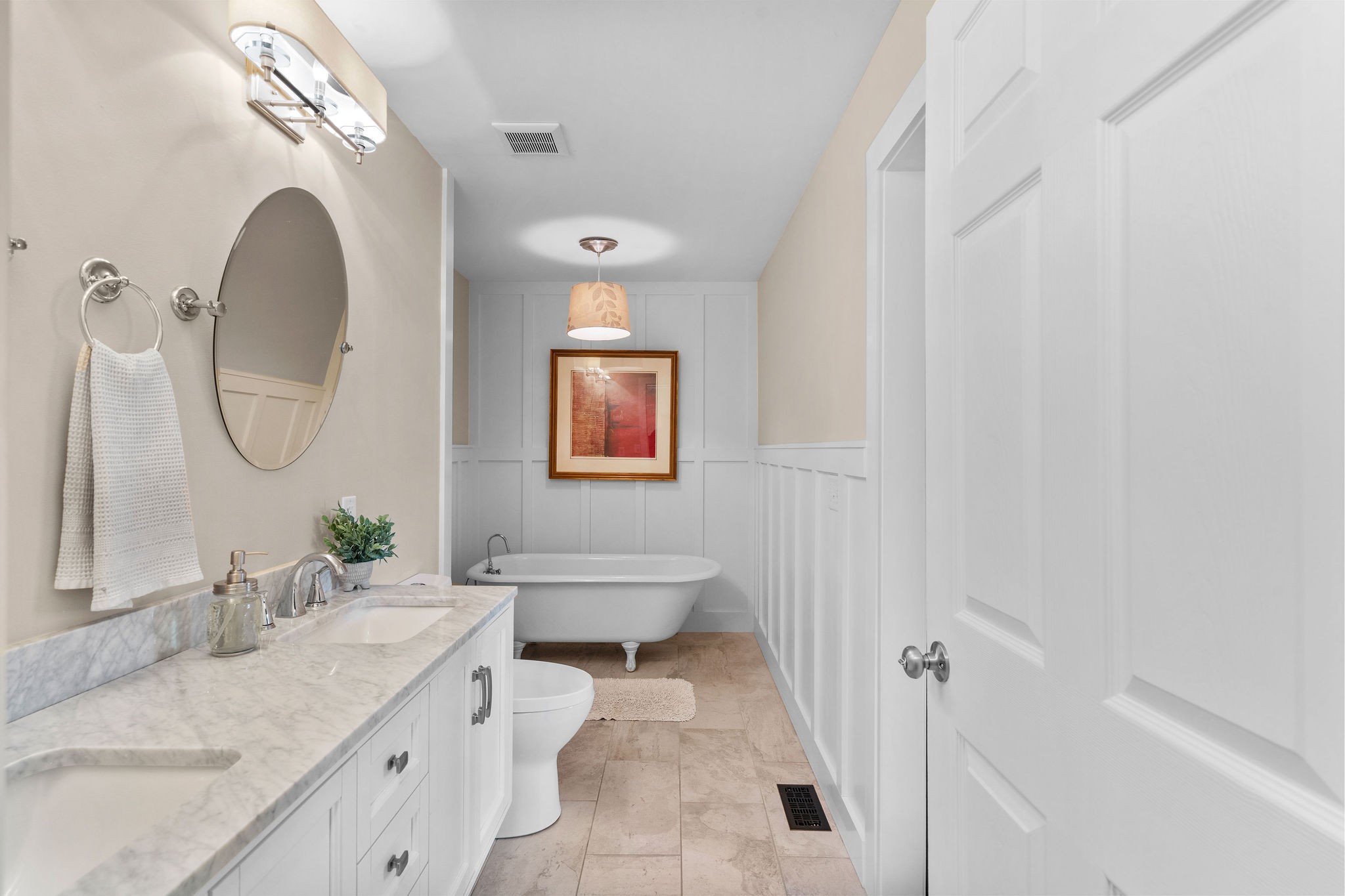 The antique cast-iron clawfoot soaking tub was rescued from a historic home in Franklin, TN. There are two separate walk-in closets for the primary bedroom – one in the bedroom and one off of the full bath.