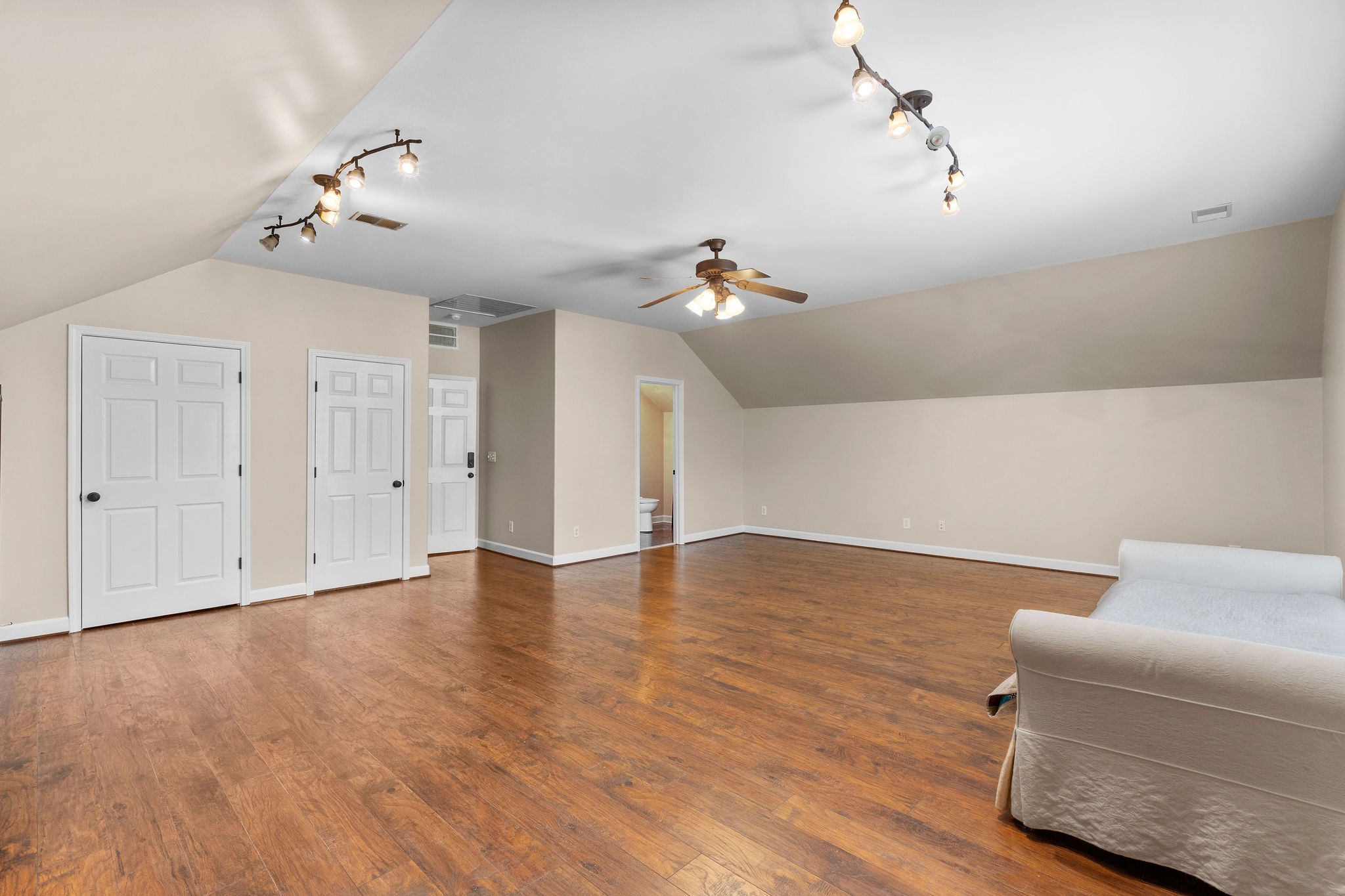 Another view of the bonus room. The doors to the two closets are on the left in the photo. The door to the right leads to a full bath.