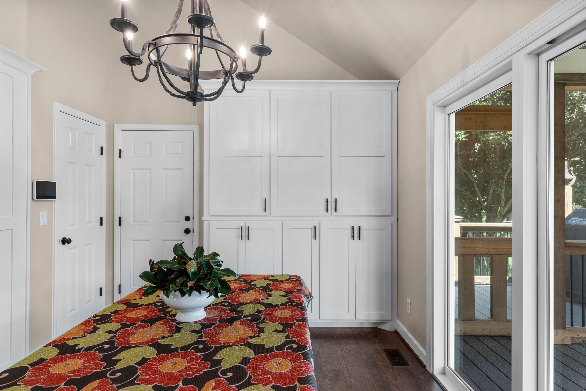 The door on the left is the “petite pantry.“ The center door is the garage entrance. The large primary pantry to the right of that is also Amish-built with a adjustable shelving.