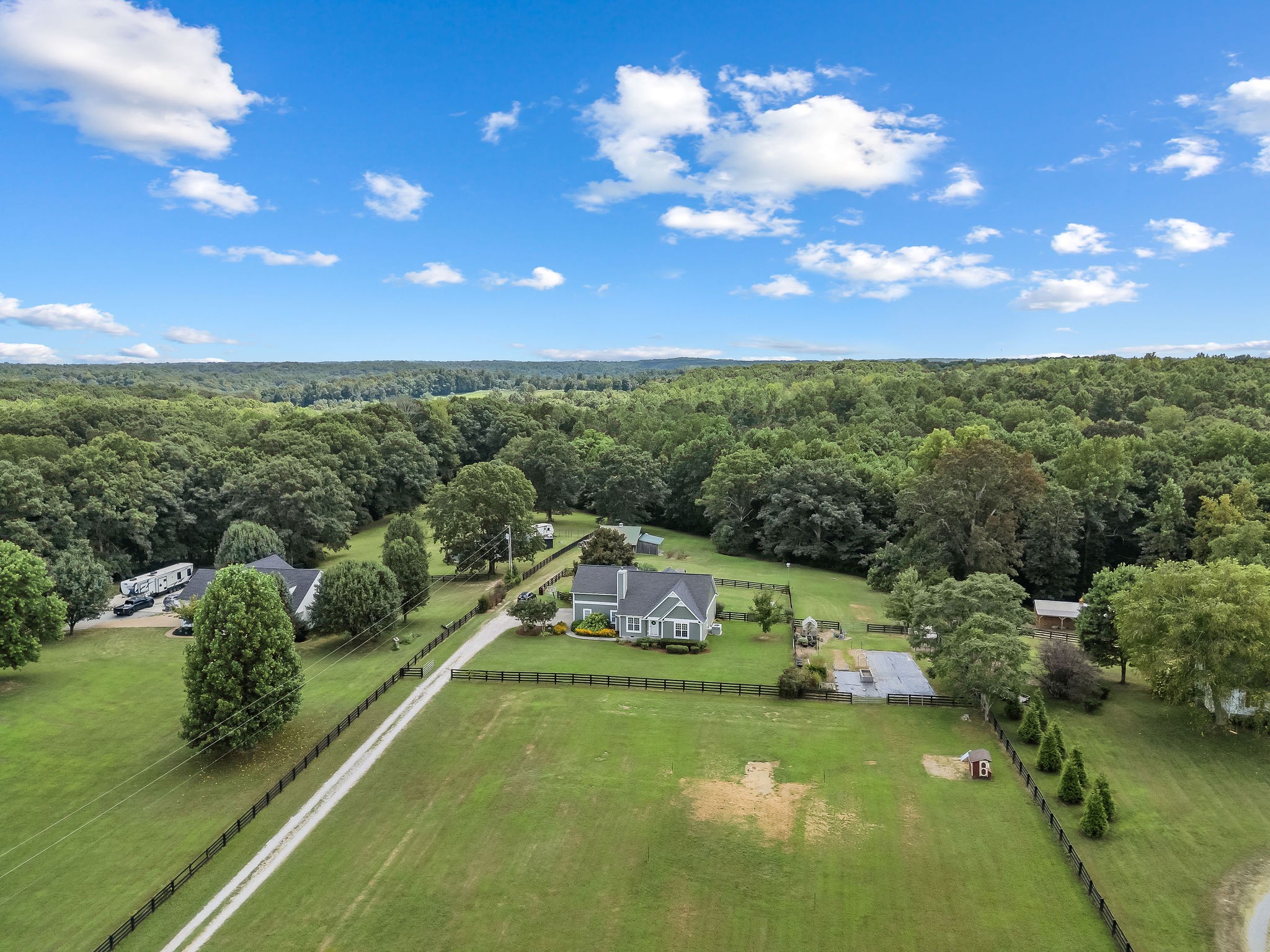 The fenced garden area can be seen to the right of the house. The garden is between seasons and is covered now to keep the ground ready to be planted by the new owners.