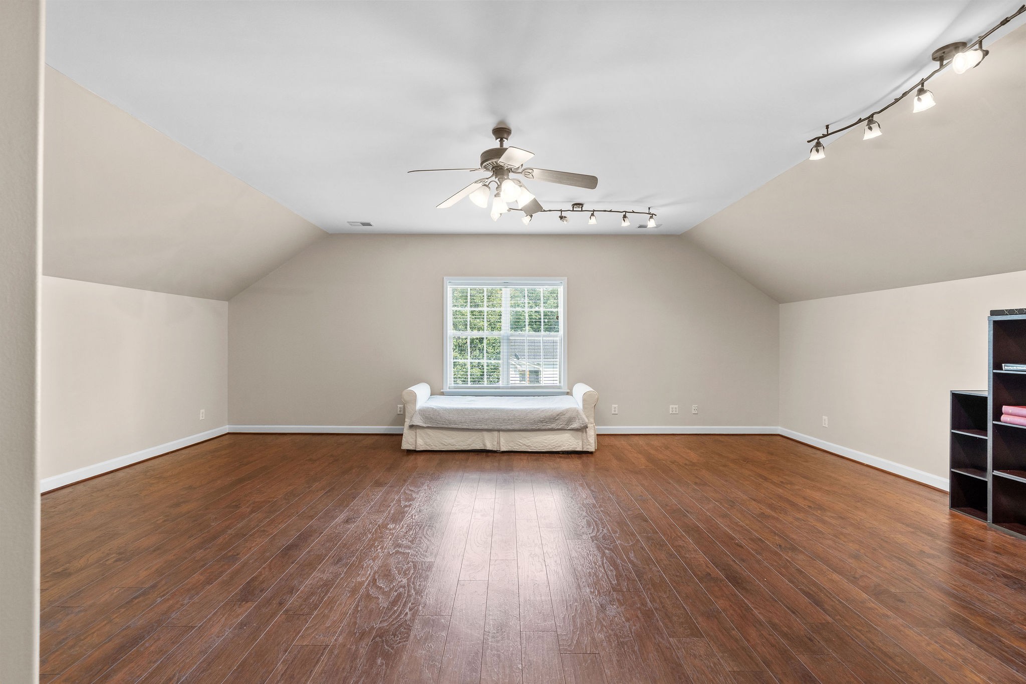 This large bonus room is located on the second floor. It features wood flooring, wood paint, two closets and has its own private full bath! It’s also the location of the whole-house attic fan.
