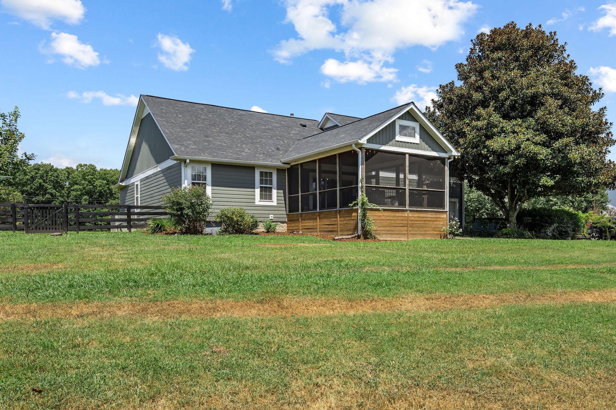 Another view of the house from the backyard shows the large magnolia tree which shades the porch and yard. The smell of the magnolia blooms in the spring is absolutely intoxicating!