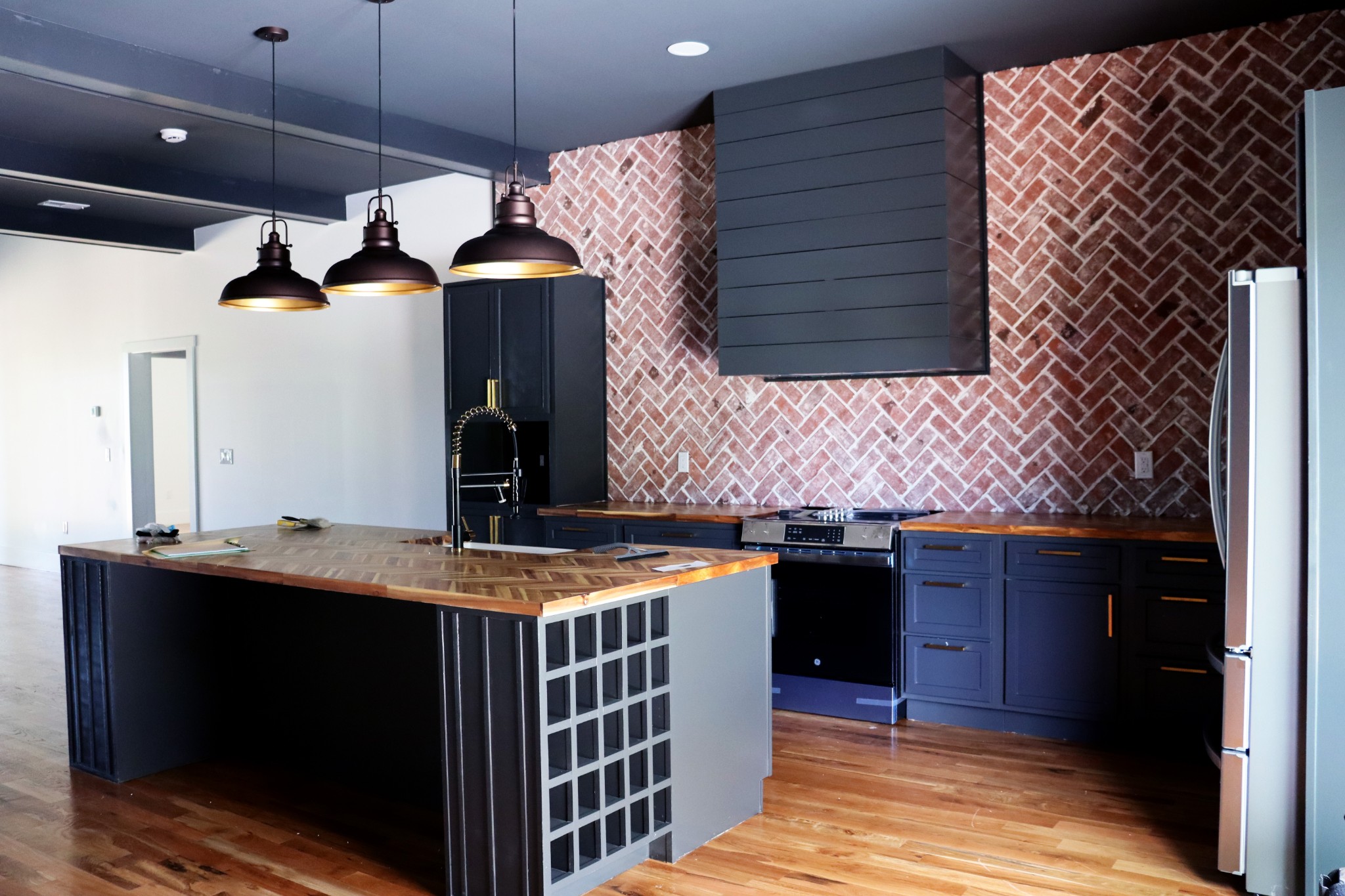 Herringbone pattern wood counters add elegance to an already elegant kitchen.