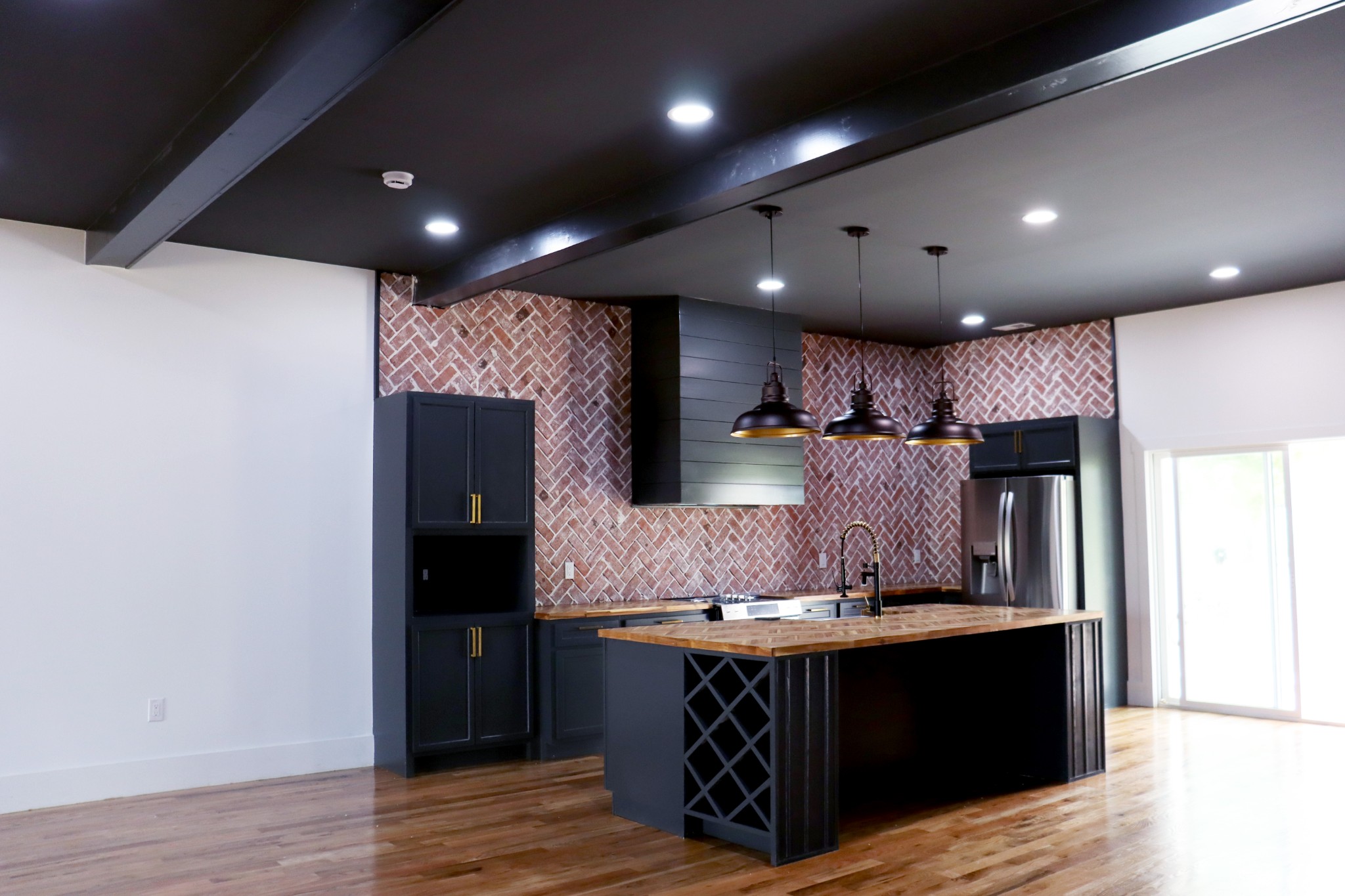 Exposed Brick accent wall completes this kitchen.