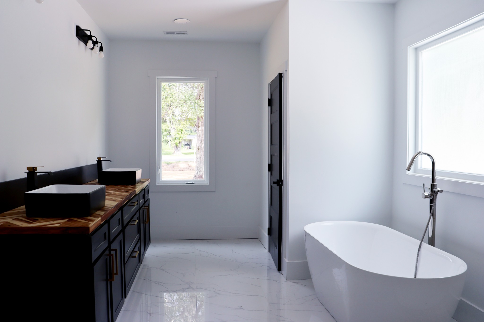 A luxurious bathroom for personalized space. Double Vanities, a soaking tub and a tile shower make getting ready for your day easier.