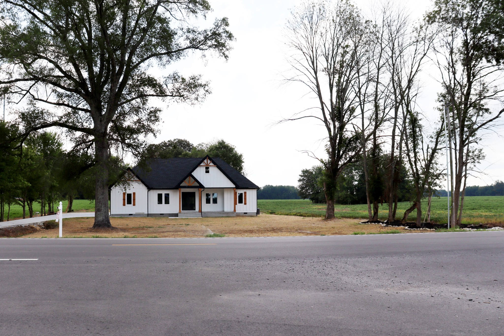 Farm land & blue skies surround this beautiful home.