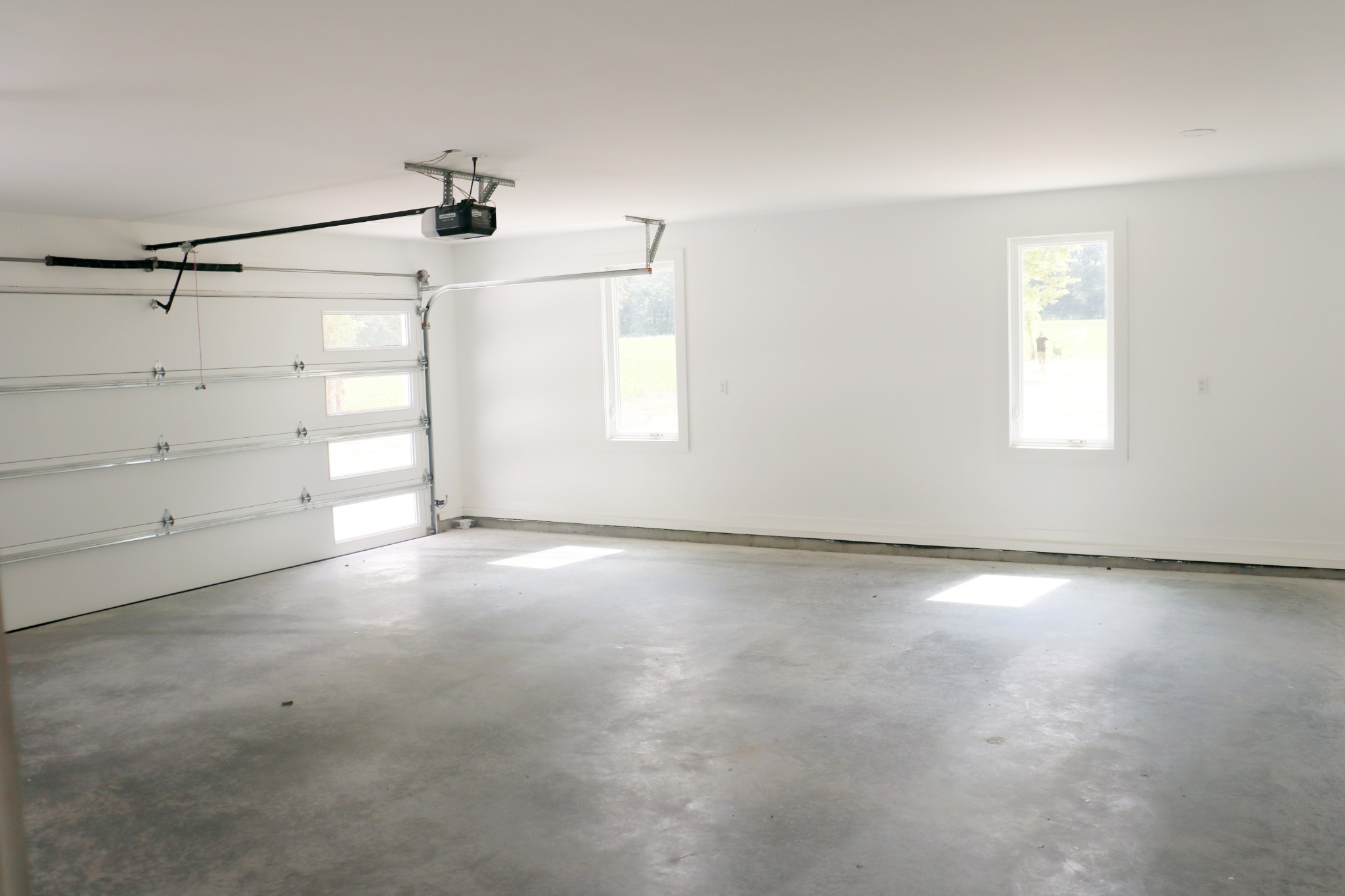 Two car garage with horizontal windows in door.