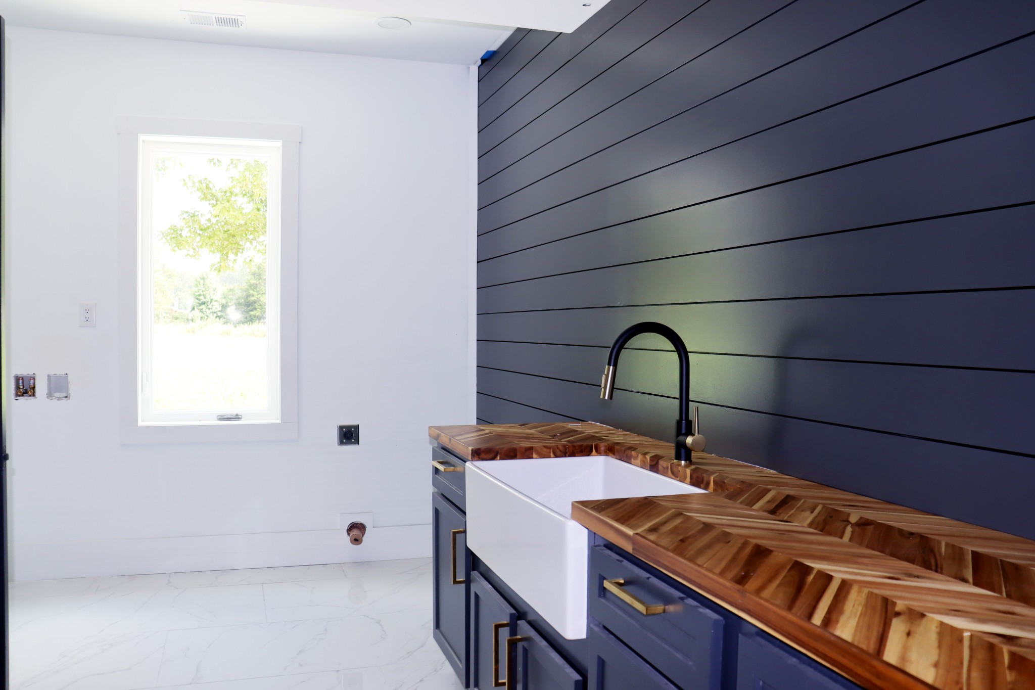 The Utility Room has a farm sink and folding table.