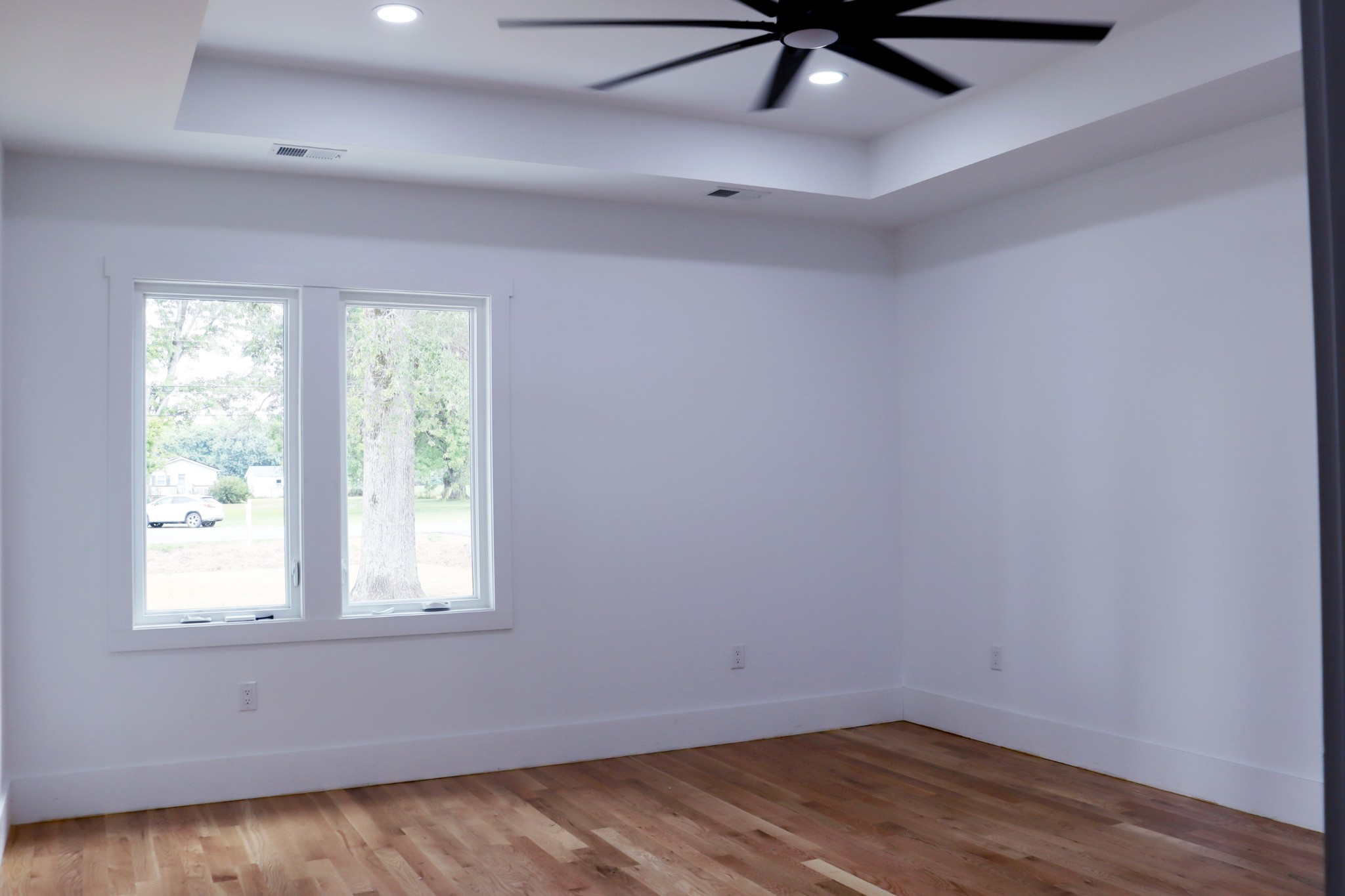 This15x17 primary bedroom will easily accommodate a king-sized bed. The tray ceiling and ceiling fan are added touches.