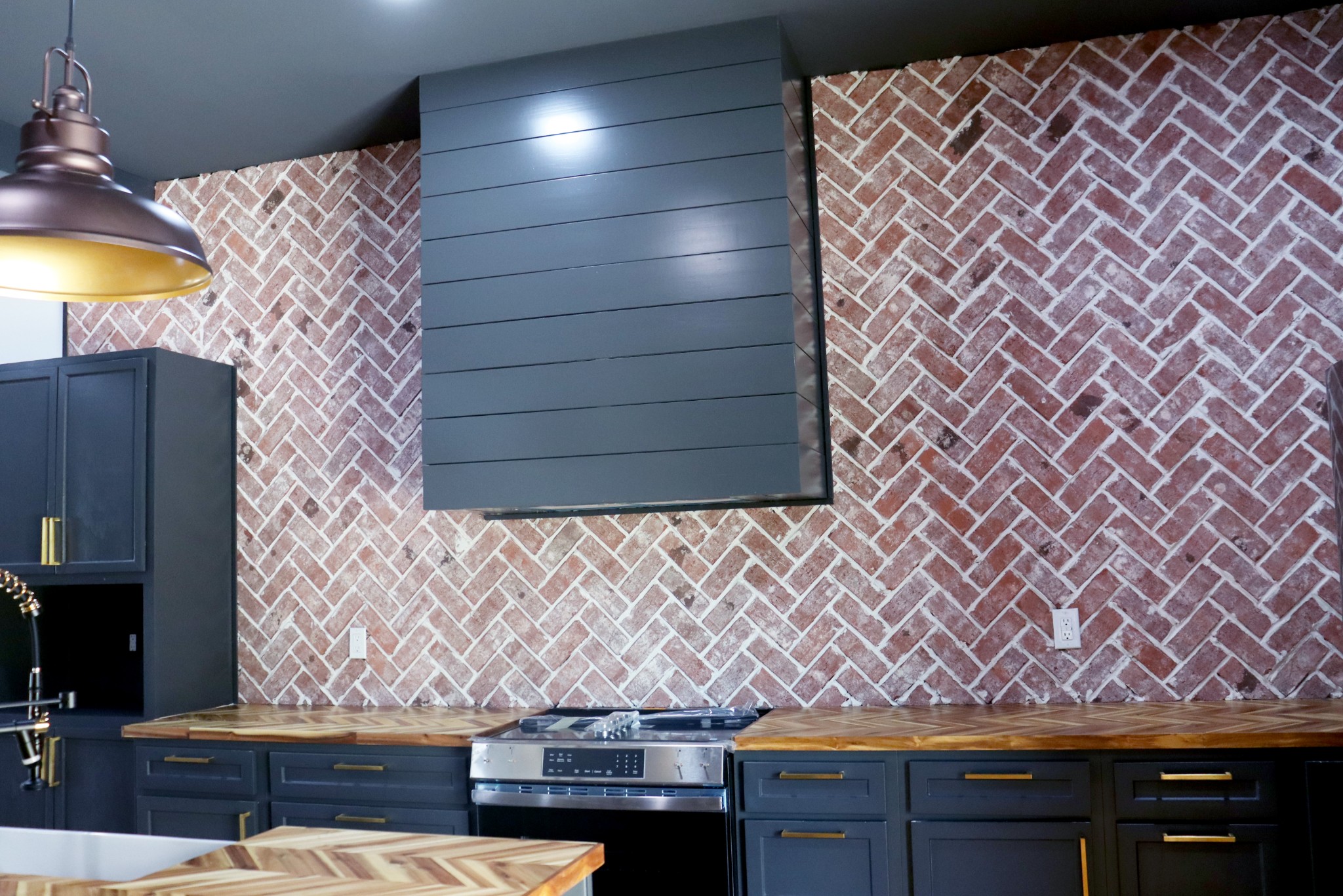 The custom designed range hood is beautiful.