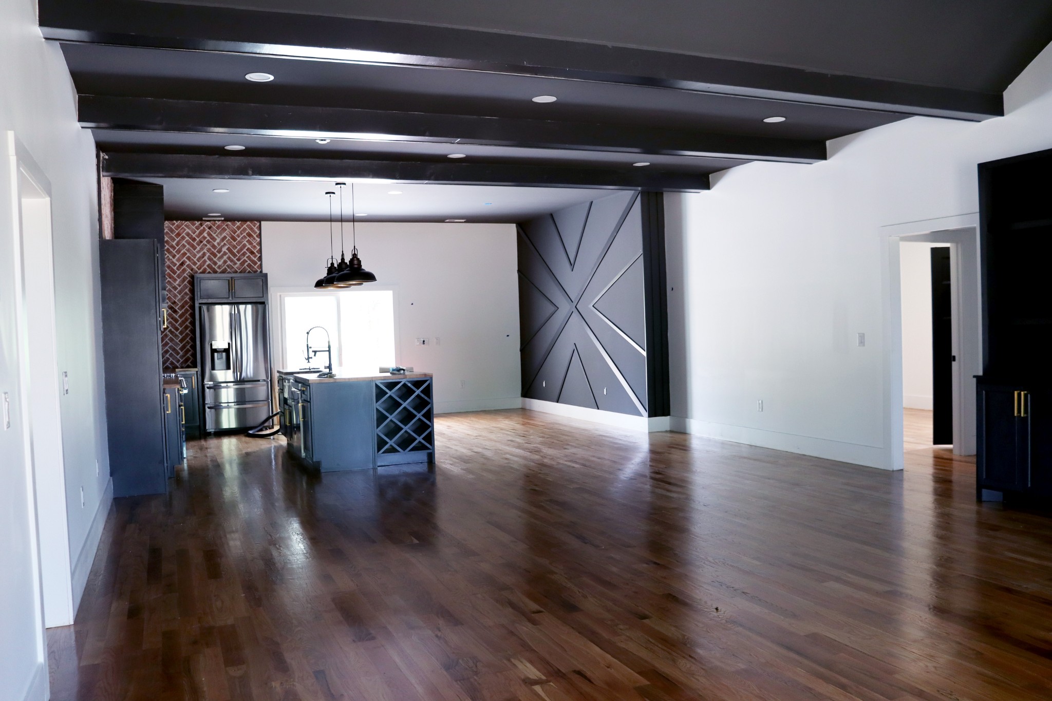 Notice the accent wall in the dining room with design at its best.