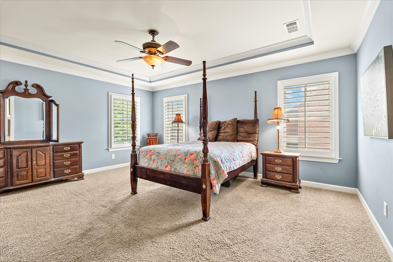Primary space with tray ceiling, beautiful moulding and tons of space