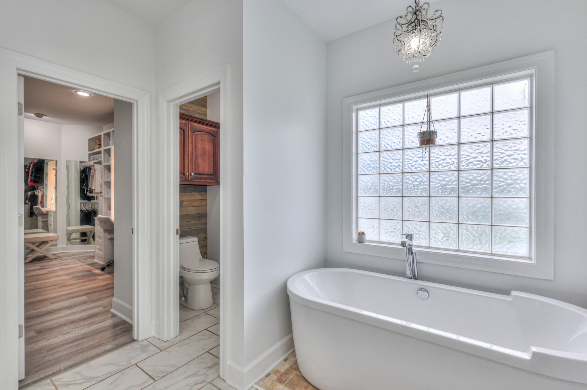 Leading into the designer master closet for her