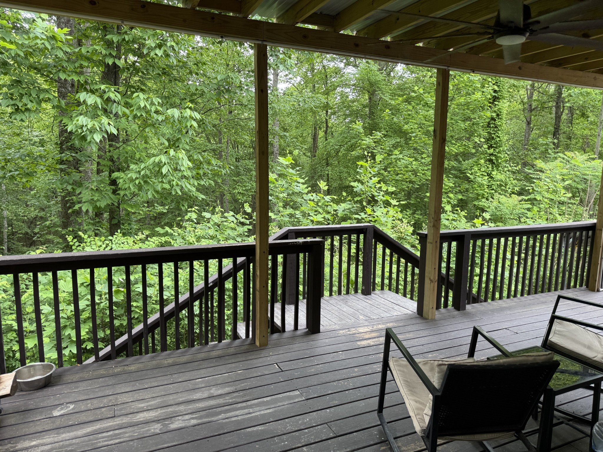Covered deck with ceiling fan and water mister.