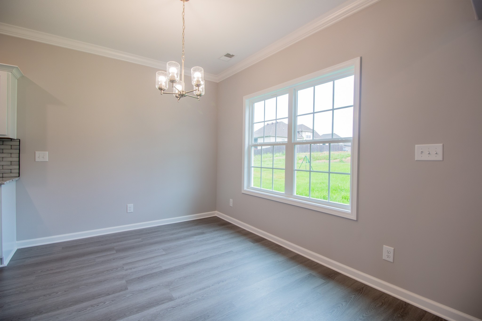 Eat-In Area with a Beautiful Chandelier and Natural Lighting Overlooking the Backyard!
