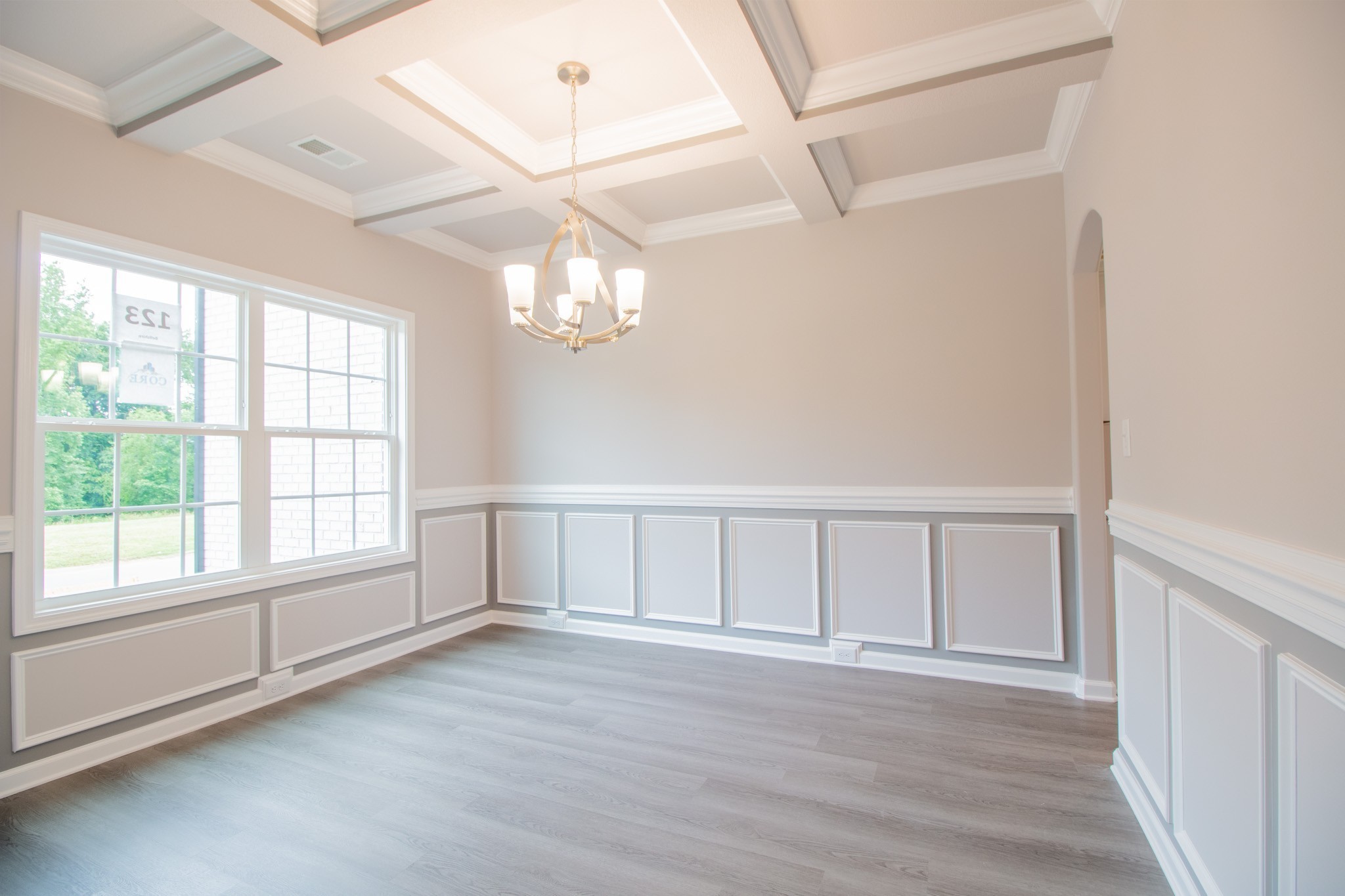 Large Formal Dining Room with Chair Railing, Wainscoting and a Coffered Ceiling!