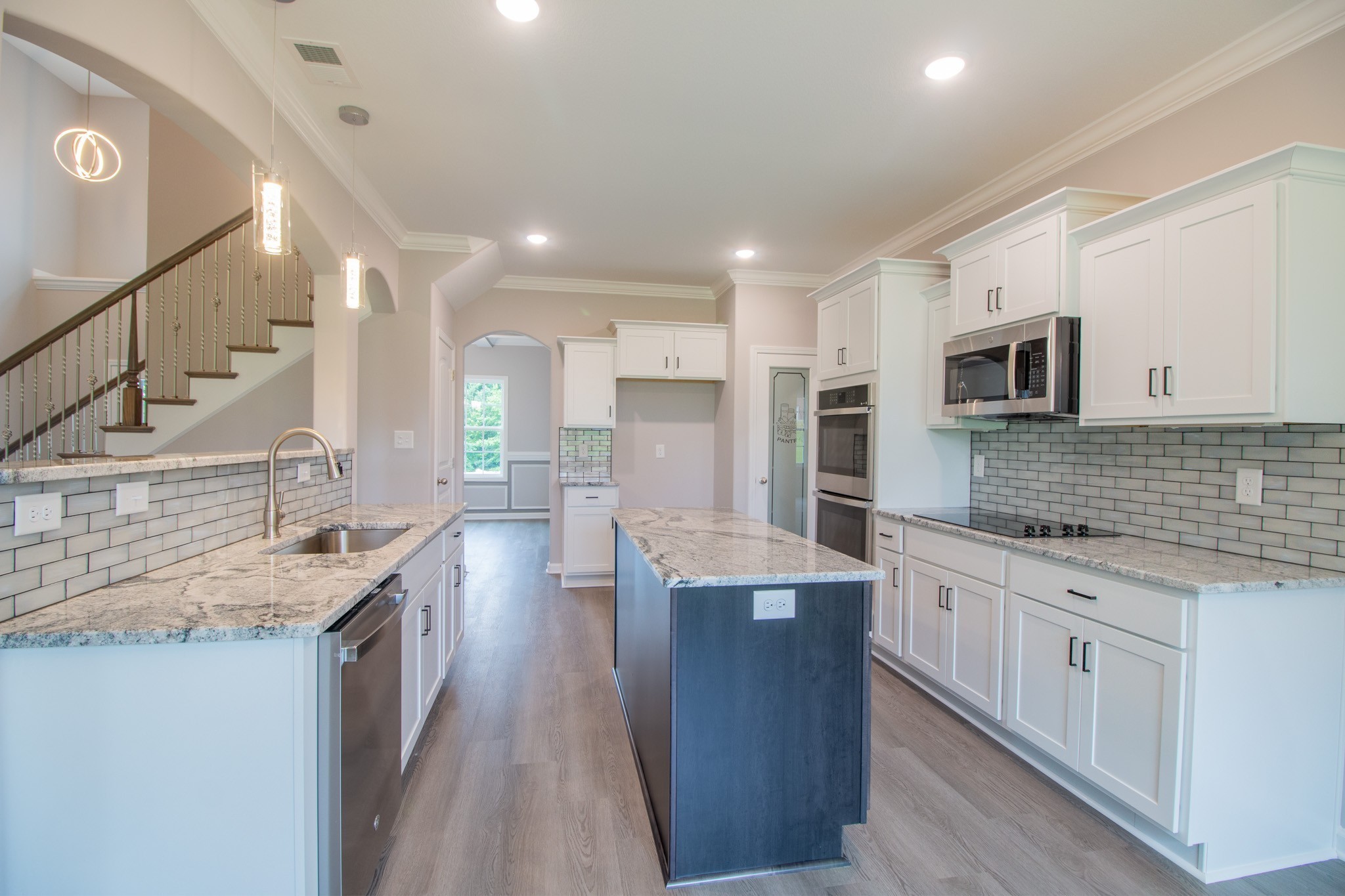 Large Kitchen with a Cooktop, Smart Double Oven, Granite Countertops, Tile Backsplash, Recessed Lighting, Bar Area and Lots of Cabinetry - All with Soft Close Doors & Drawers!!