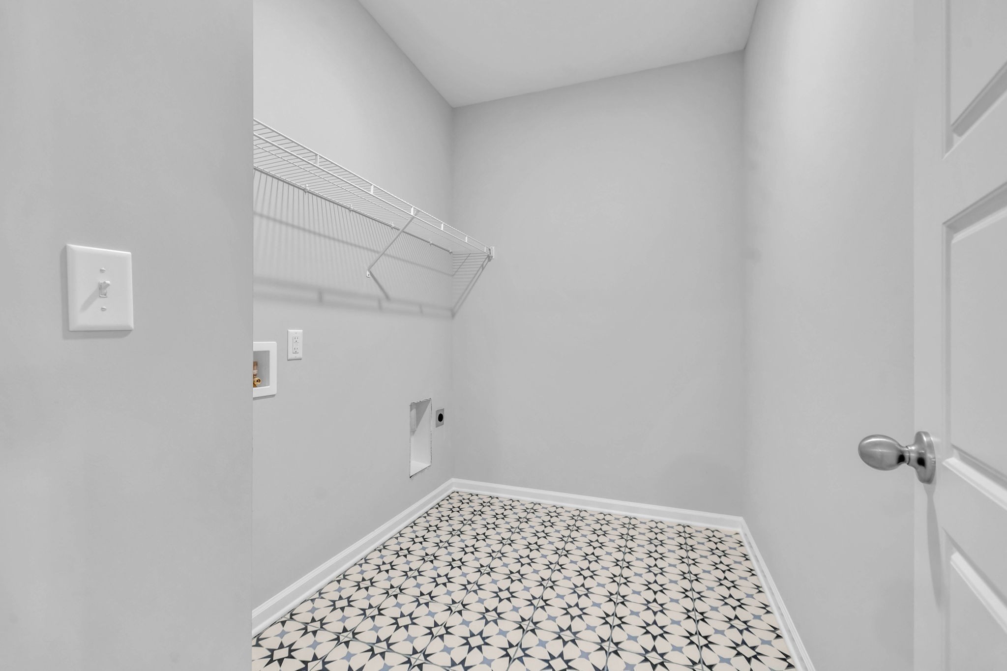 Oversized Laundry Room Located on the Main Level with Ceramic Tile Flooring.