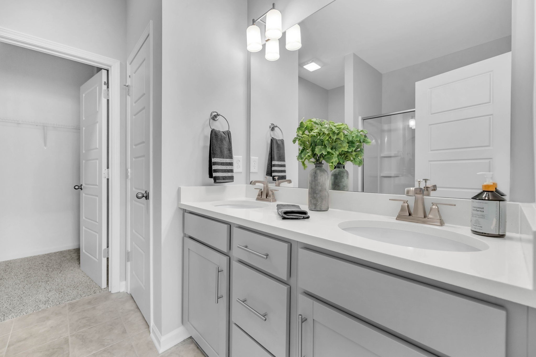 Primary Ensuite Bath with Dual Vanities, Large Walk-In Closet, & Linen closet.
