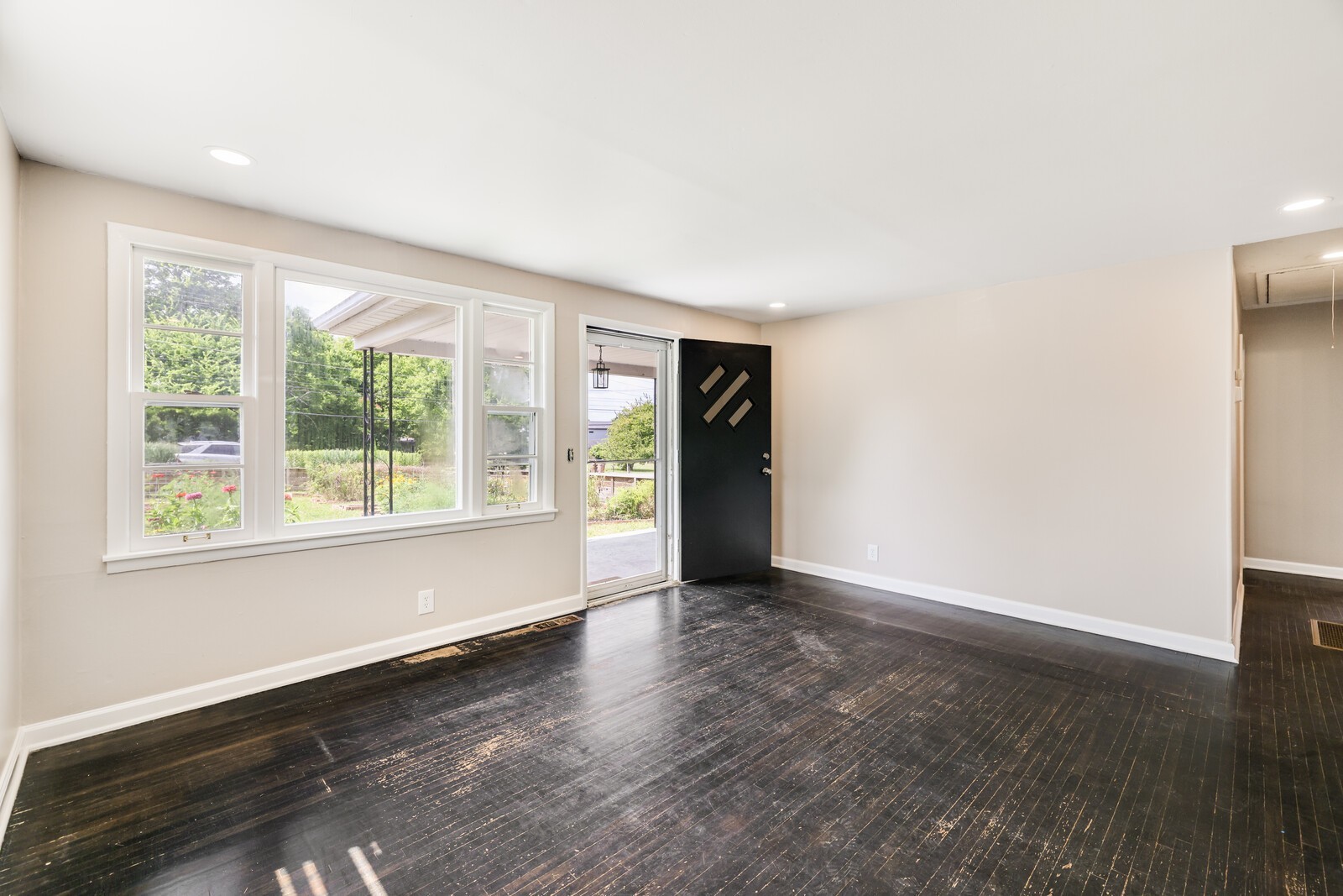 As you enter the home, you come into the living room via the recently painted front door. Enjoy lovely windows that overlook the front gardens