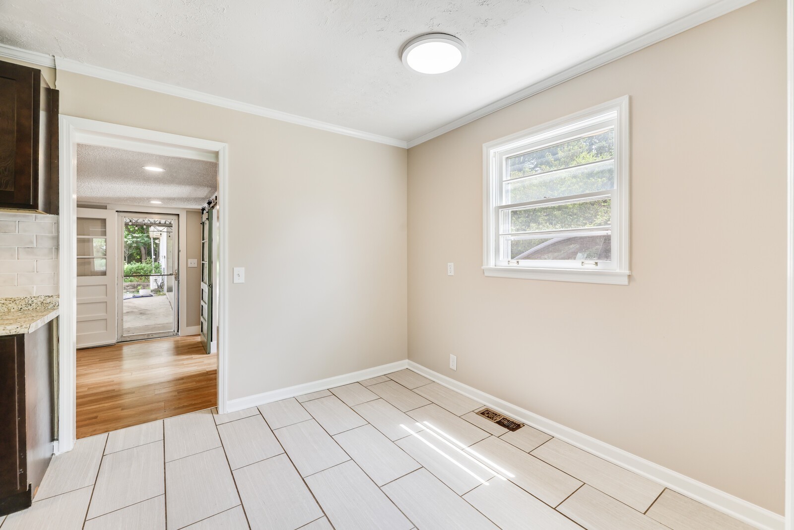 The kitchen flows into the flex space with laundry room