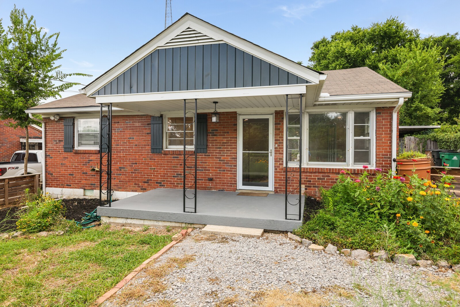 An inviting covered front porch welcomes your guests in--and provides a lovely spot to relax and enjoy the front yard