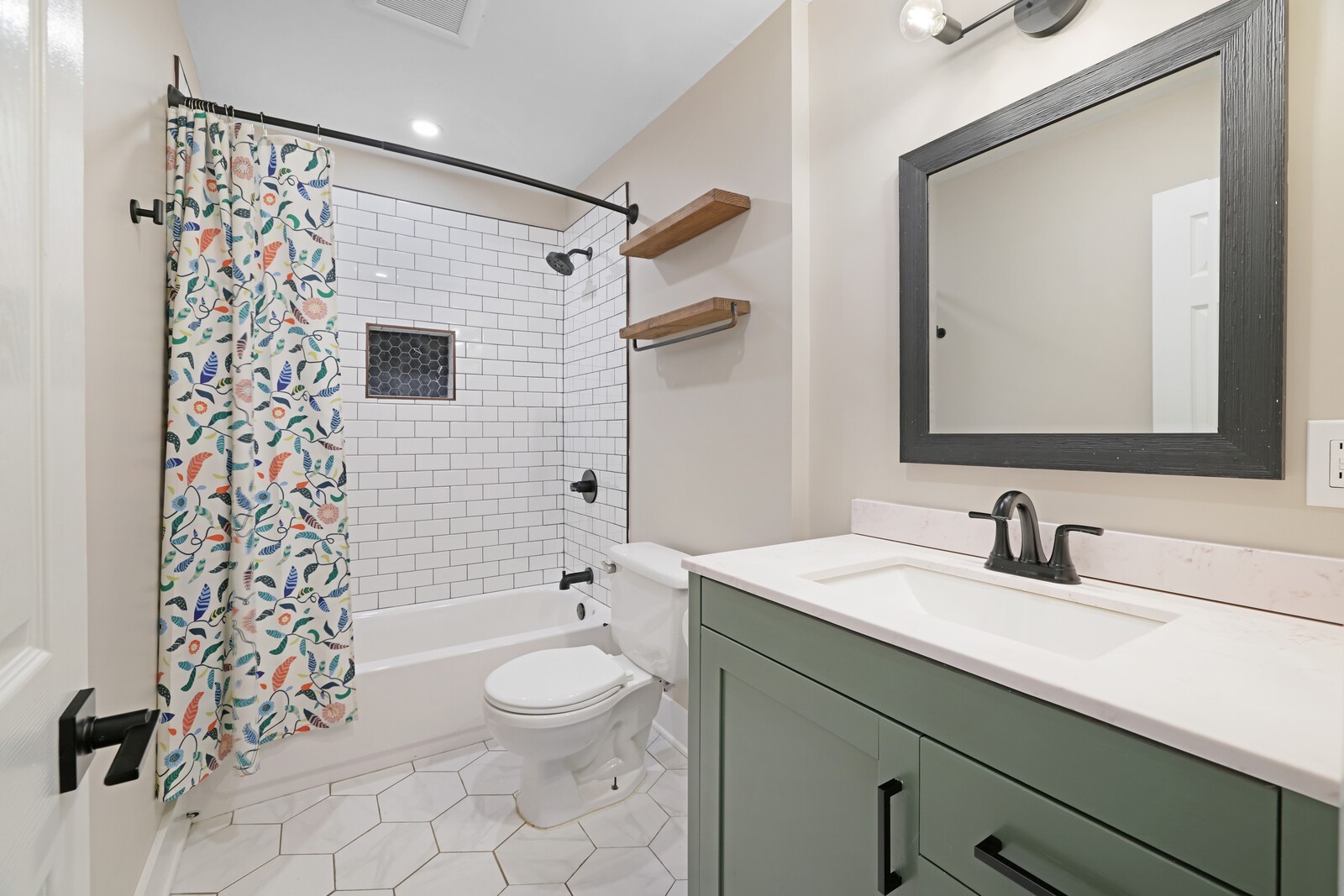 The secondary bath has lovely updates with a fully tiled shower/tub combo!