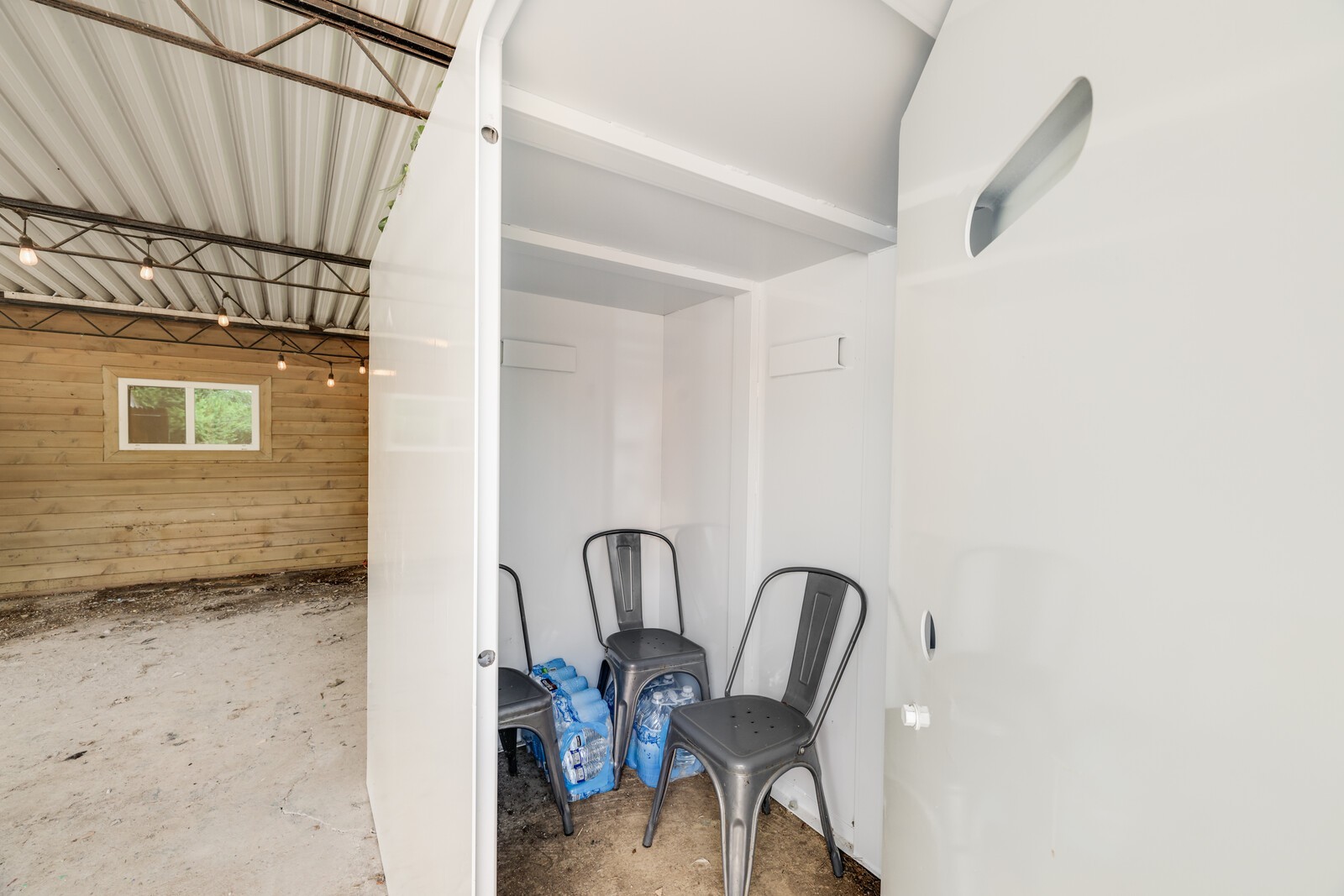 The tornado shelter is located in the carport