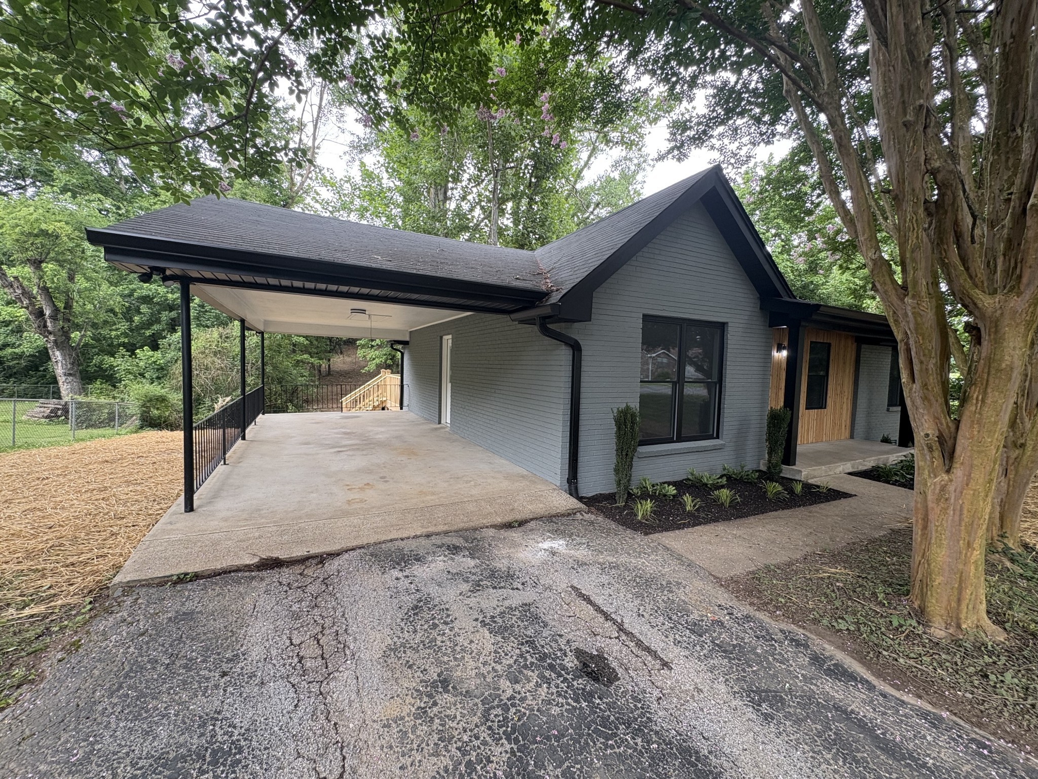 Large carport to make grocery day easy, helping family to get inside smoothly - or it would make a great side patio!