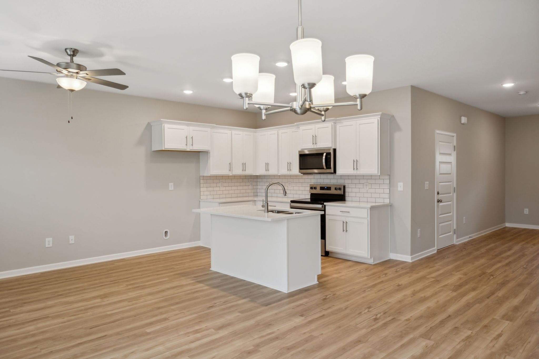 Open Concept Kitchen/Great Room Area with Island Bar that Also Promotes a Formal Dining Space.