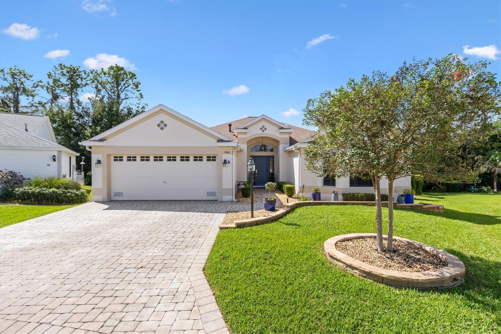 SUPER LOCATION! PRIVATE CUL DE SAC LOT! Exquisite 3/2 expanded CBS Lantana Designer home in the Village of Santiago on Cul de sac with no homes behind. NO BOND!  New Roof 2023, HVAC 2017. Close to Spanish Springs Town Square and Lake Sumter Landing, Glenview Country Club and Championship Golf Course, Savannah Regional Recreation Center, Santiago Family Pool, and walking distance to El Santiago and El Diablo Golf Courses and Recreation Centers.Stunning brick paver driveway and walkway, complemented by custom landscaped grounds lead to a charming covered front porch. Step inside to an elegant entry foyer adorned with a decorative stone wall. The open and split floor plan showcases ceramic tile, plantation shutters, and recessed lighting on dimmers, while two bedrooms feature attractive wood-look laminate flooring. The spacious living room boasts a large glass plate window for breathtaking views and a decorative wood wall with floating shelf. French doors open to a serene covered back porch perfect for relaxation. Access the back yard from the porch via stairs and enjoy your private dining patio. The dining nook features a charming window seat with tinted windows that invites you to unwind and connect with nature, while the remodeled kitchen is a chef's dream with upgraded Viking Double Oven and Gas Cooktop with grill, GE Profile Refrigerator, newer Dishwasher, Upgraded Cabinets, QUARTZ countertops, quartz and a stylish diamond-patterned tile backsplash. Additional features in the kitchen include breakfast bar, small island, pantry closet and additional Butler's pantry in the large Laundry/Utility room. The primary bedroom features French doors with Storm Doors leading to a private Juliette balcony with awning. The primary bath has a skylight, relaxing soaking garden tub, walk-in shower, make-up vanity and large walk-in closet. The guest bedrooms share an ungraded bath with tub shower combo and solar tube. One bedroom, without a closet, is perfect for work, study or craft room. Additional features that make this home special are ceiling fans throughout, central vacuuming system, skylight in Kitchen and Master Bath, energy saving Gas hot water heater, new garage door opener and epoxy garage floor, irrigation drip system, termite bond, and 3 zone heating and air condition control. Some furniture available separately. Please watch our video of this spectacular home! Make your appointment so you can savor life all The Villages and surrounding area have to provide.