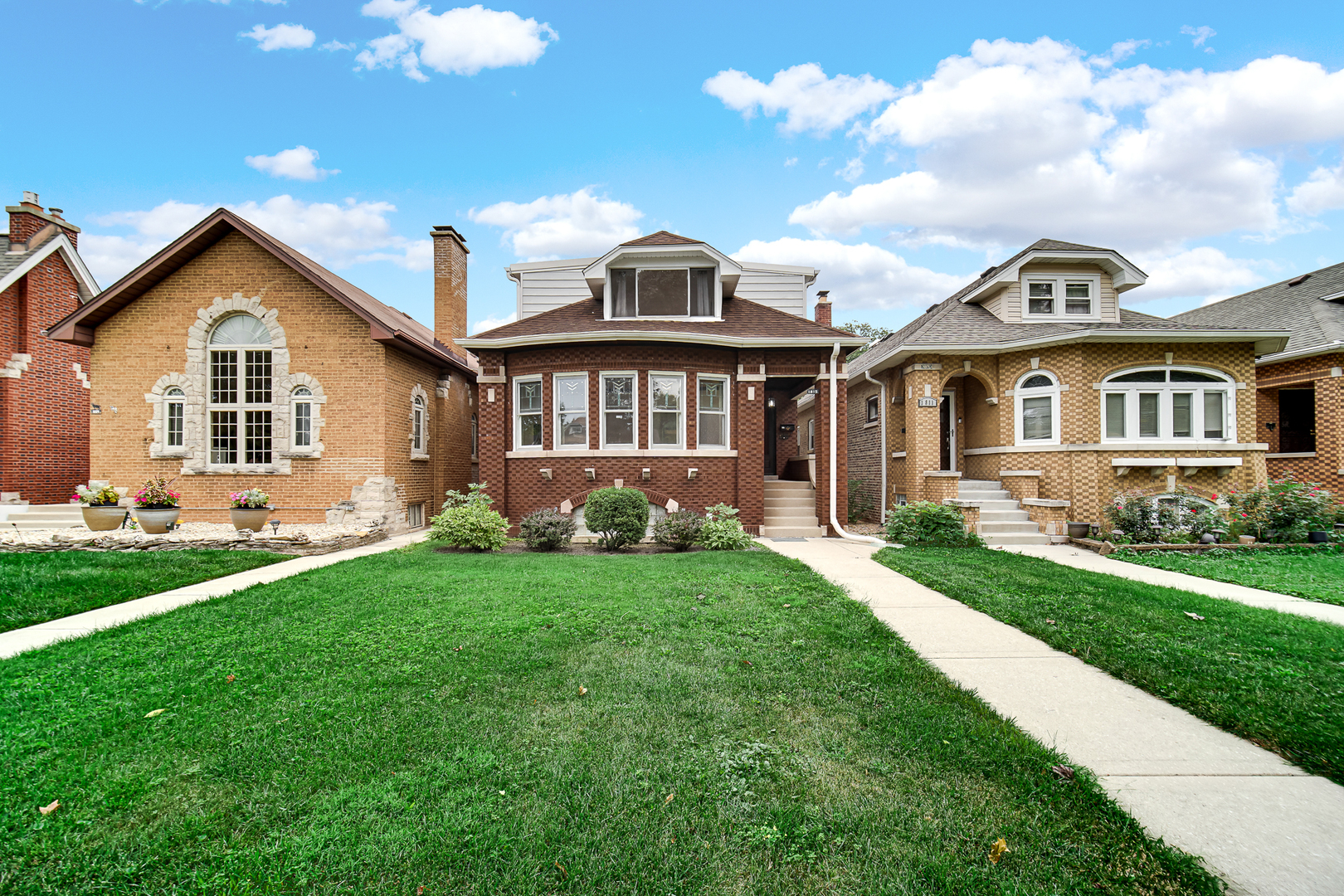 Massive 4BR/3BA, Two Full Kitchens, Related Living Setup & Backyard Oasis, in Prime Chicago Location!    Looking for space, it's here, More than 2400 sq ft!!!! This 4-bedroom, 3 full bath home has many updates and has been painted throughout. It blends timeless original charm-including 9 original stained-glass windows and gleaming original hardwood floors with the many modern conveniences. This home is entirely turn-key and move-in ready. The main level boasts a spacious living room with gas fireplace, and separate formal dining room. The renovated kitchen has 42 in cabinetry, kitchen island, stainless steel appliances, quartz countertops and recessed lighting. Also on the main level is the flexible sunroom (home office, reading, relaxation or yoga space) and a functional mudroom ready for custom hooks and shoe storage. The main level has 2 large bedrooms, both with walk-in closets and original hardwood floors. The expansive upper level can serve as a Luxury Primary Suite, In-Law Suite or Related/Multi-Generational Living space. This level has 2 Large Bedrooms, 2nd bedroom has 2 closets, including a deep walk-in closet. Full kitchen with dining area is also included on the upper level. The walk-out basement is an entertainment hub with massive space to create multiple open zones to accommodate a home gym, theatre, children's play area, and family play areas too!!! The basement walk-out door leads to more family fun and entertainment in the backyard. This exterior part of the home has paved patio, gazebo, beautiful bricked water fountain, 2 car garage and electrical outlets for evening entertaining. This home is conveniently located less than 15 miles west of Downtown Chicago, with quick interstate access. Property is steps away from a rich variety of local shopping, dining, and vibrant community entertainment options. Come, See and Call It Home!!!