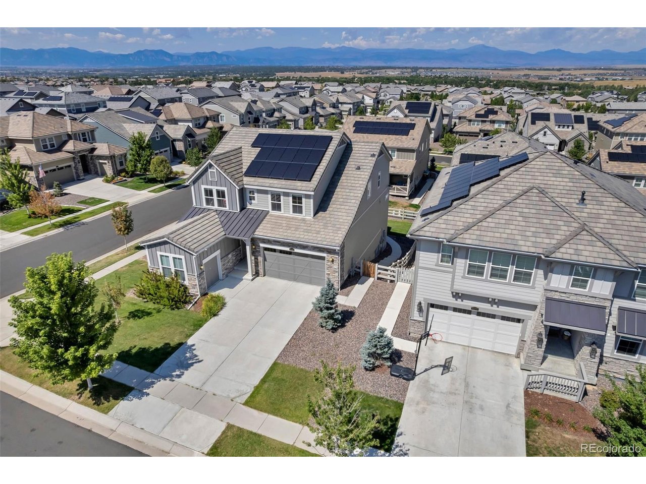 Stunning mountain views, exceptional living space, and a finished walkout basement come together in this beautifully maintained two-story Colorado home. Offering 5 bedrooms, 5 bathrooms, a dedicated main-level office, solar for energy savings, and an impressive 4-car garage that includes a versatile gear bay-this home was designed with both everyday living and entertaining in mind.Filled with natural light, the open-concept main level features stylish finishes and inviting spaces throughout. At the heart of the home, the spacious kitchen showcases an oversized island, abundant white cabinetry, granite countertops, subway tile backsplash, stainless steel appliances, and plenty of room to gather. The kitchen flows seamlessly into the dining area and expansive great room, where a dramatic wood-slat accent wall and fireplace create a warm and sophisticated focal point.Upstairs, retreat to the spacious primary suite, featuring beautiful mountain views and a luxurious 5-piece bathroom with the convince of an upstairs laundry room. There are 3 additional bedrooms upstairs, each with an ensuite bathroom. The finished walkout basement takes this home to another level, adding incredible flexibility with a large recreation room, additional bedroom and bathroom, plus a dedicated office/flex space-ideal for guests, working from home, a fitness room, or hobbies. Step outside to the landscaped backyard and covered outdoor living area, where you can entertain, unwind, and take in the beautiful Colorado backdrop. The walkout design creates a seamless connection between the finished lower level backyard making the space even more functional for gatherings and everyday enjoyment. Located in the desirable Anthem subdivision, this home is exceptional with mountain views, multiple work-from-home options, solar, a finished walkout basement, and a rare 4 car/gear bay garage. This home truly offers the space, versatility, and Colorado lifestyle you have been looking for.