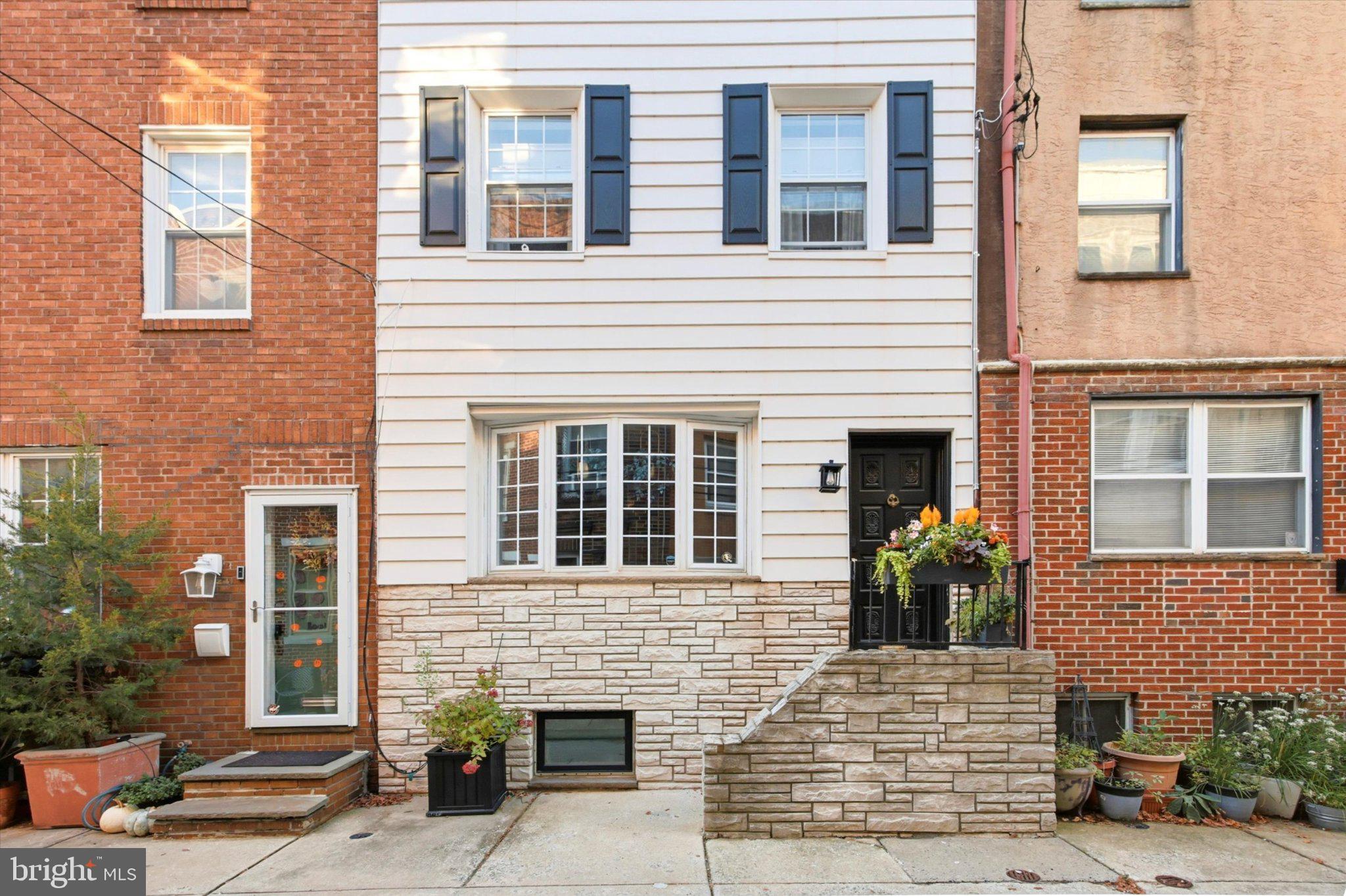 Every once in a while, a property comes along that is truly special, one that exudes warmth, charm, and originality. 722 S Mildred is one of those places. Impeccably maintained, with thoughtful updates made by its current owner, this home sits on a quiet, tree-lined street in vibrant Bella Vista, bordering Queen Village, and in the MEREDITH SCHOOL CATCHMENT, easily one of the best in the entire city. Built around 1920 as a 3-bedroom and later reconfigured as a 2-bedroom with bonus space, the home offers real flexibility and there is so much to love here. As you stroll down the block, you can’t help but be taken by the famous mosaic art environment close by and iron railings with planters brimming with fall flowers. Upon entering, it’s evident that this house is anything but typical. Its 17' width and set-back stairs create a wonderfully warm and open feeling, and the originality continues with the fabulously updated kitchen, featuring ample custom cabinetry/open shelving and a wall of windows overlooking the home’s quaint patio which is accessed through its own private glass door. The open lower level has wide stairs leading to a finished space with a powder room and a large storage area. On the 2nd floor, you’ll find the primary bedroom with ample closet space, a charming updated full hall bath, a laundry area, and a small bonus space next to the laundry, currently used as an office. Up on the 3rd floor is the second bedroom with an adjoining bonus room, currently used as a den, which can easily be converted to a third bedroom with the addition of a wall. So although this home is currently set up as a 2 bedroom, between the 2nd and 3rd floors, there are actually five rooms in all, including the bathroom. The den features soaring vaulted ceilings, beautiful wood floors, and its own glass door which opens to a small roof with exterior electric outlet, just waiting to be transformed into a quaint Parisian-style terrace. Recent updates include a newer HVAC system, freshly painted front exterior, custom wallpaper and interior paint, new kitchen tile, a replacement hot water heater, and more. The location is also second to none. Aside from being a foodie heaven (steps away from Mawn, Angelo’s, Good King Tavern, and Saloon, just to name a few), you’re also just a few blocks from several parks, including Palumbo Park, and from Whole Foods. It’s also centrally located and easily walkable to Passyunk Avenue, Queen Village, and Headhouse Square for more food, fun, and shopping. You do not want to miss out on this fabulous home!,