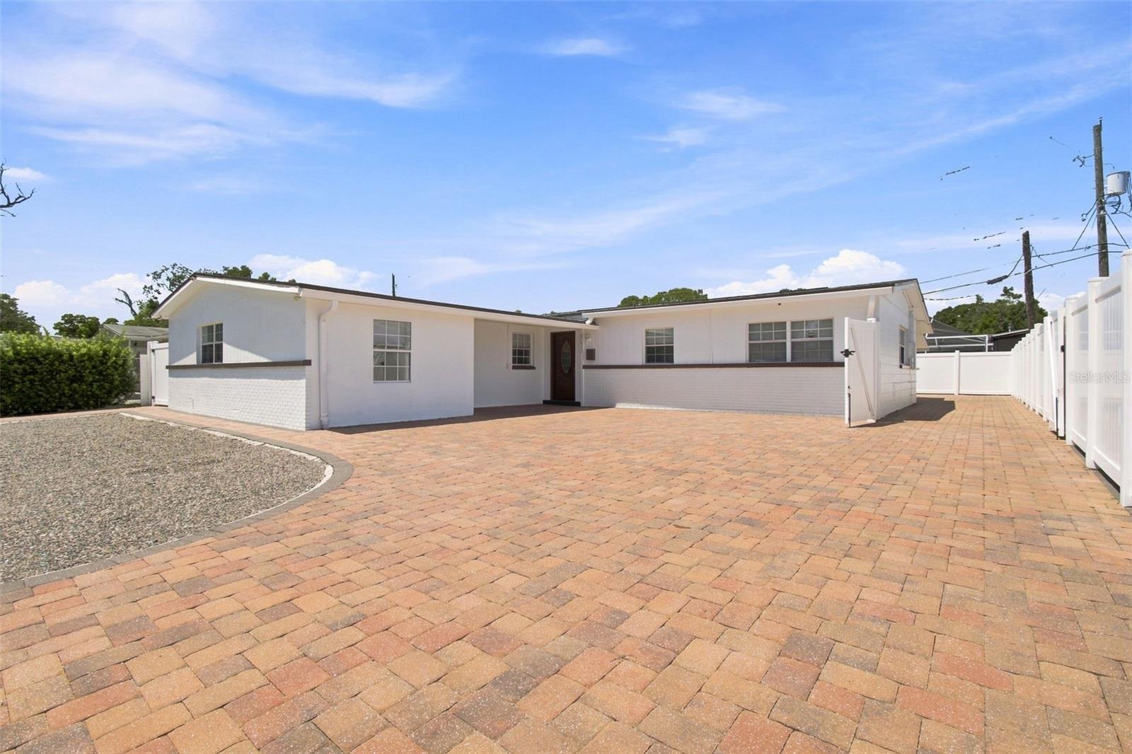 Welcome to this highly versatile 6 bedroom, 4 bath concrete block home, thoughtfully configured to accommodate a variety of living arrangements. One of the property’s most distinctive features is its four separate private entry living areas, each offering its own dedicated entrance and private space. Combined with the home’s generous bedroom and bathroom count, this unique configuration creates an opportunity that is difficult to duplicate, offering exceptional flexibility for multigenerational living, extended family, longterm guests, caregiver accommodations, independent living or group home use, or potential rental opportunities, subject to applicable zoning, licensing, occupancy, and governmental requirements. Buyer is responsible for independently verifying suitability for any intended use.The home features numerous important improvements, including a roof replaced in August 2025, electrical updated in 2020, a new water heater installed in May 2026, new A/C, updated plumbing, and updated windows. Solid concrete block construction with a stucco exterior adds to the home’s durability and long term appeal.Outside, over 1,300 square feet of pavers extend throughout the front and backyard, creating substantial usable, low maintenance outdoor space. The property is also fully enclosed with white privacy fencing, providing additional privacy and separation while creating plenty of space for outdoor seating, entertaining, or everyday enjoyment. Enjoy the freedom of ownership with no HOA and no CDD fees, while remaining conveniently located with easy access to Tampa International Airport and the surrounding Tampa Bay Area.All furniture is available and may be negotiated separately.